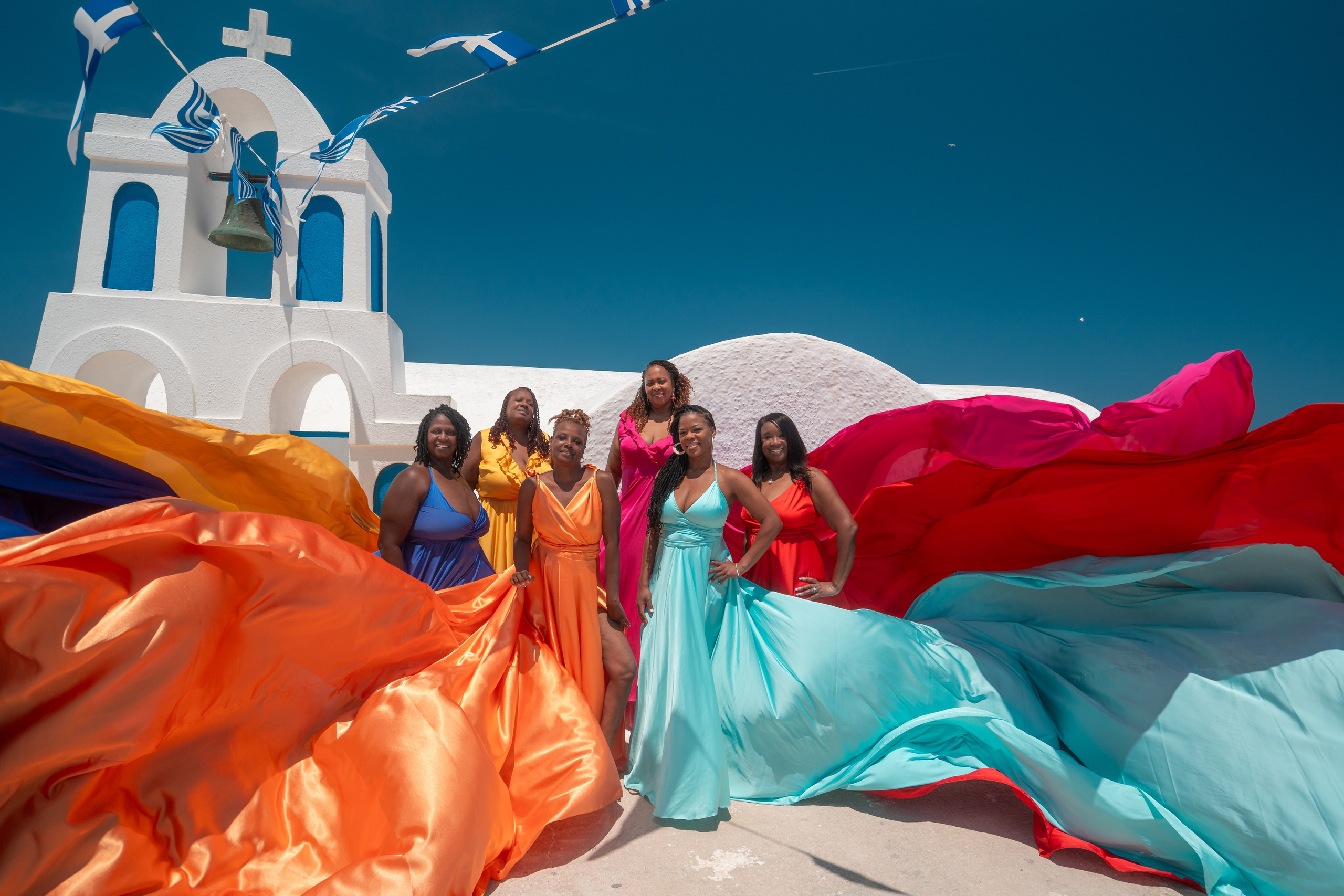 Groupe flying dresses photoshoot by Sokolove. Photographer in Santorini SokoLOVE | Flying Dress Santorini