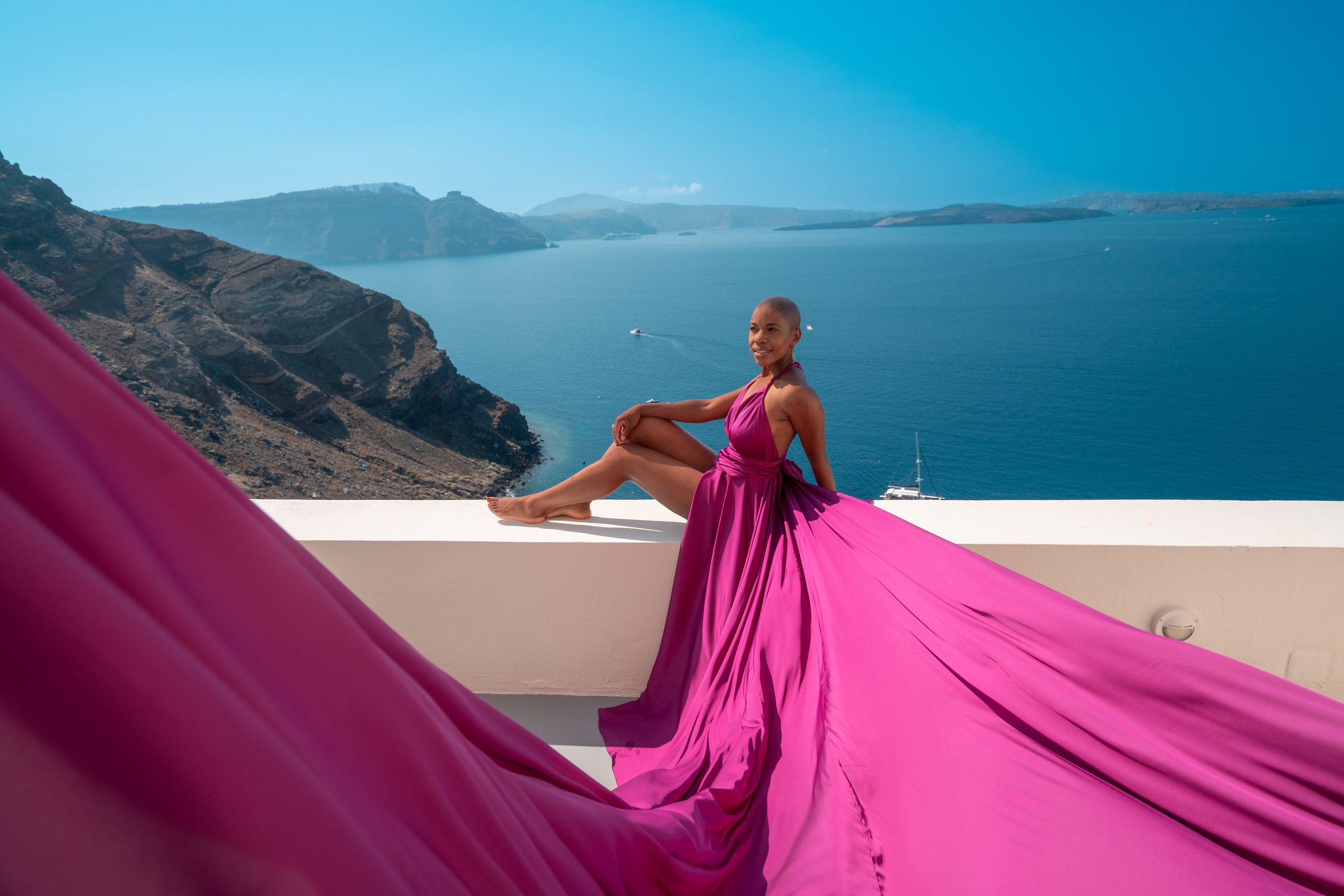 Dark fuchsia flying dress bare back in Santorini. Flying Dress Santorini Photographer | SokoLOVE — Book 2026
