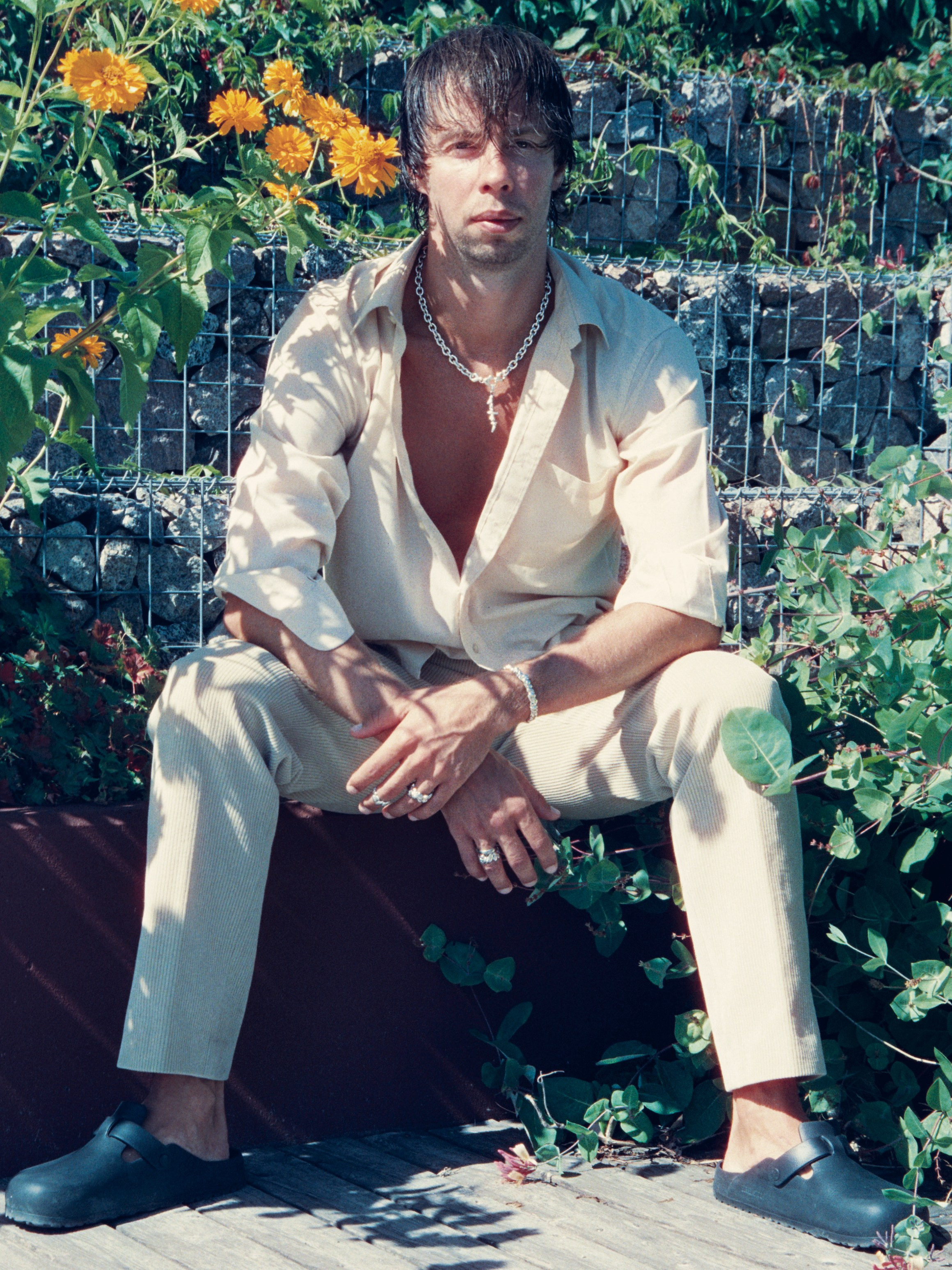 Male model wearing HYRV jewellery outdoors, 35mm film jewellery campaign photography in Estonia, Cinestill800t