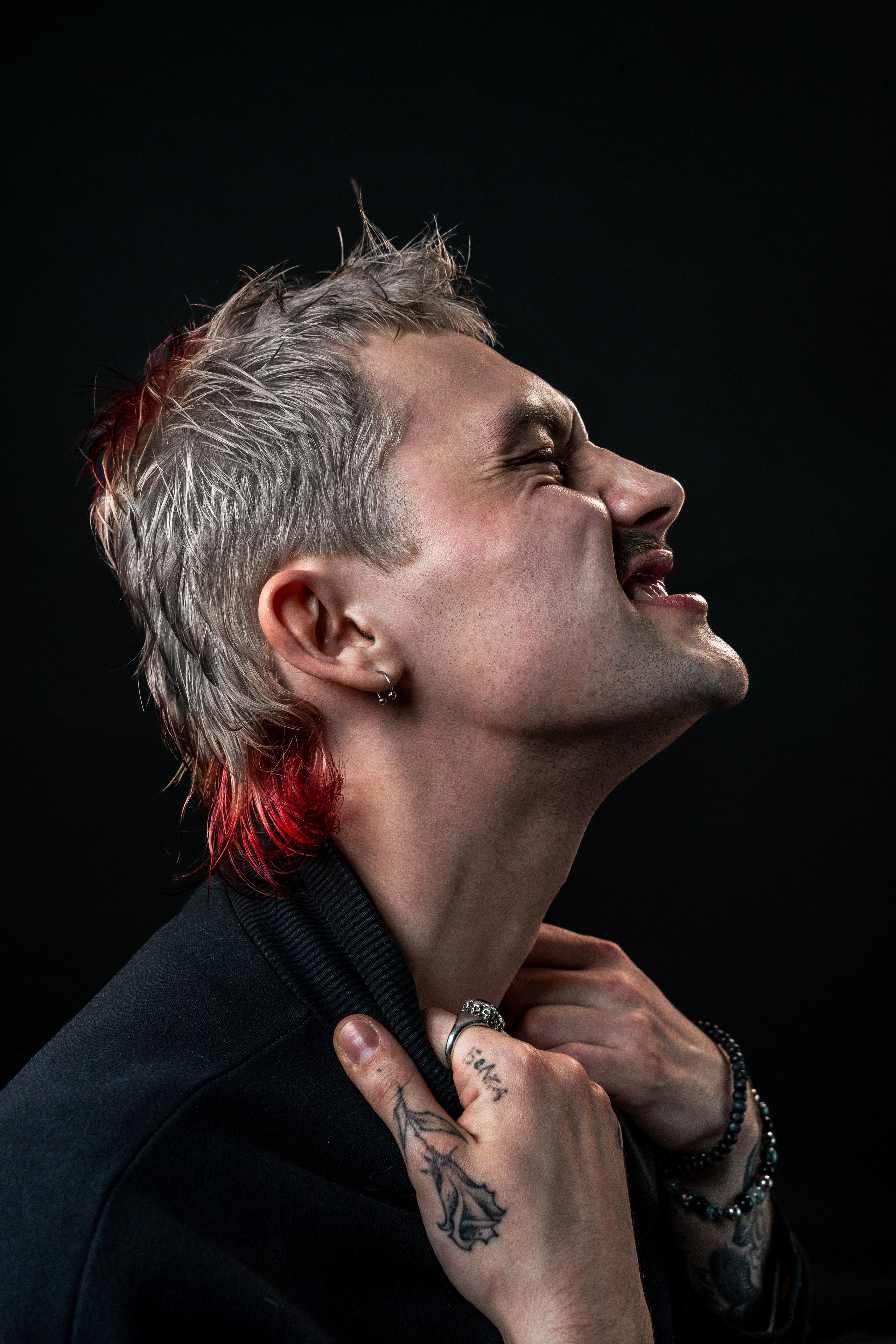 male model with tattoos and colourful textured mullet haircut