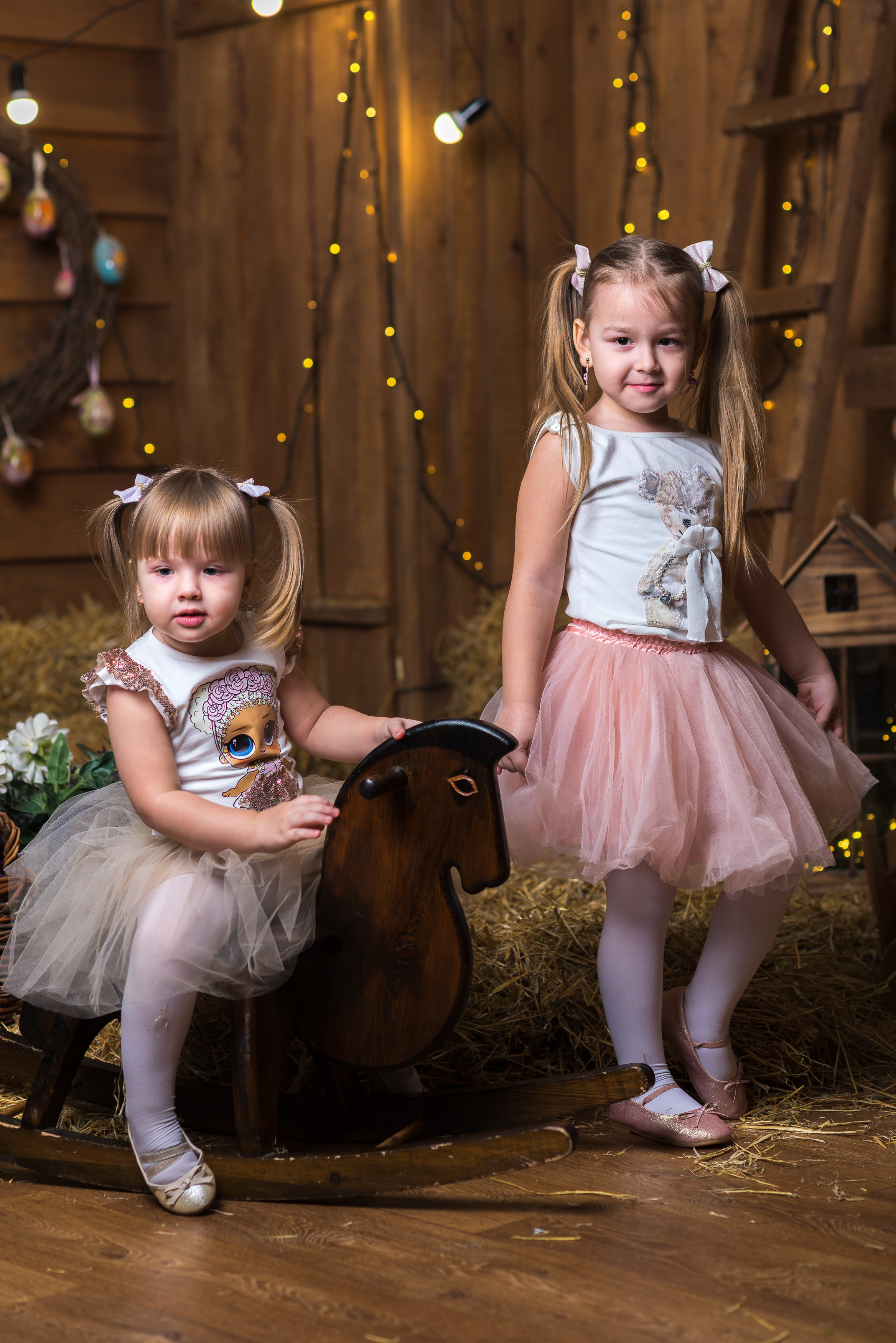 Семейная фотосессия в Днепре — две сестры сидят вместе на диване.