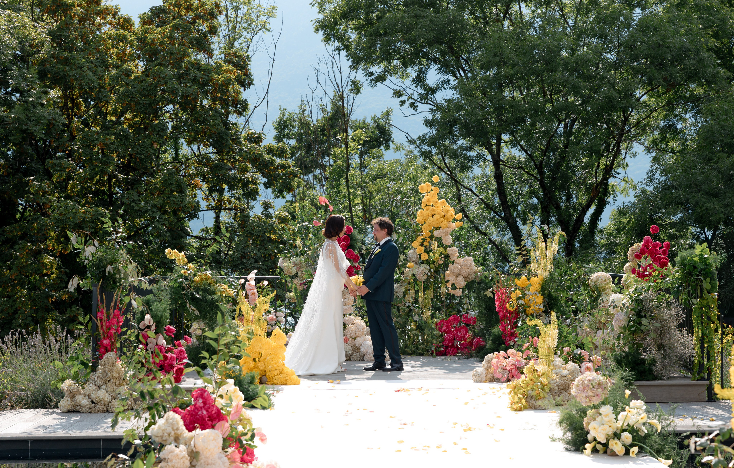 Editorial wedding portrait of bride and groom by pool at destination wedding