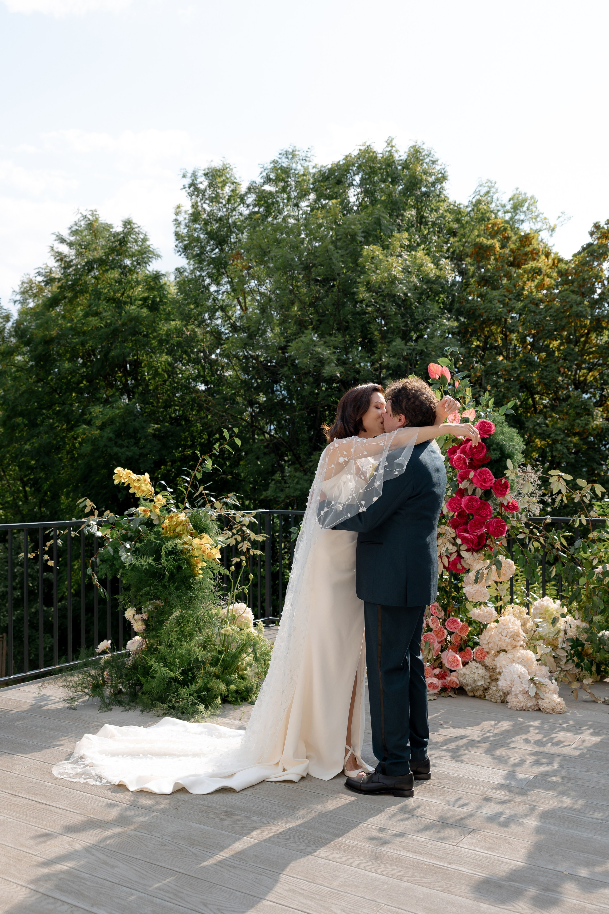 Editorial wedding portrait of bride and groom by pool at destination wedding