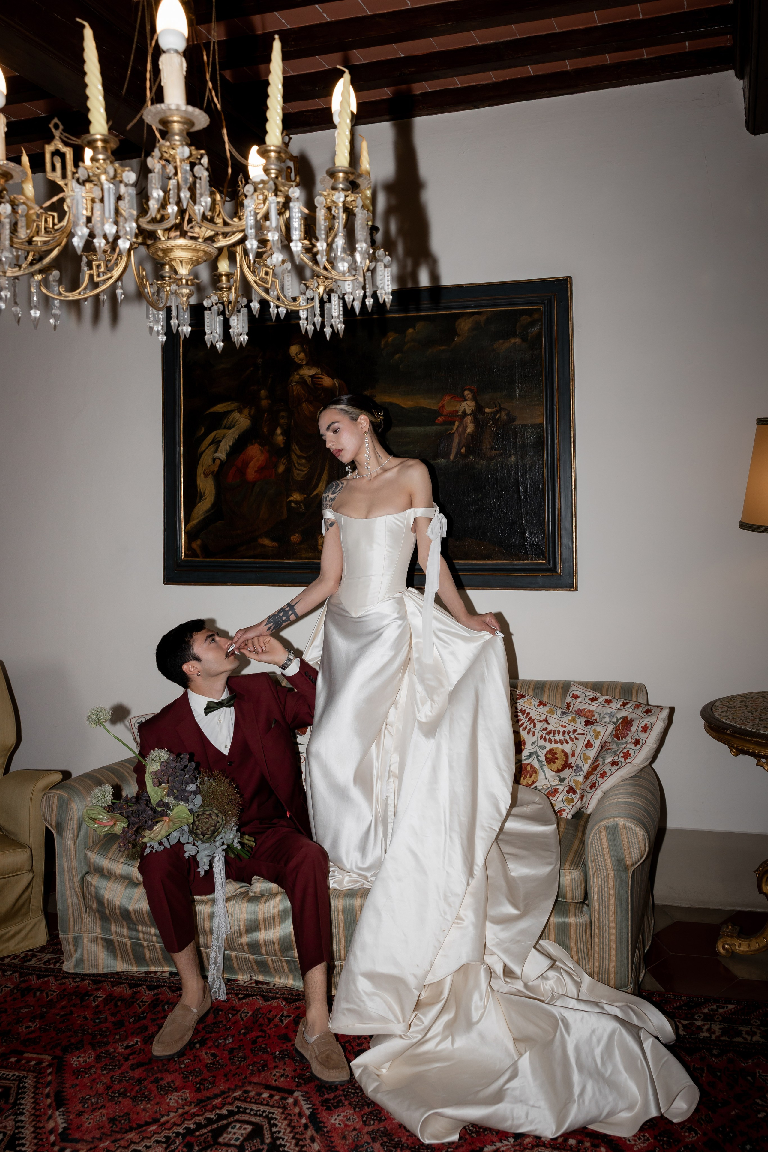 Bride in Tuscany near cypress trees on a cloudy wedding day. Elegant Italian wedding atmosphere photographed by Elena Marshall Photo.
