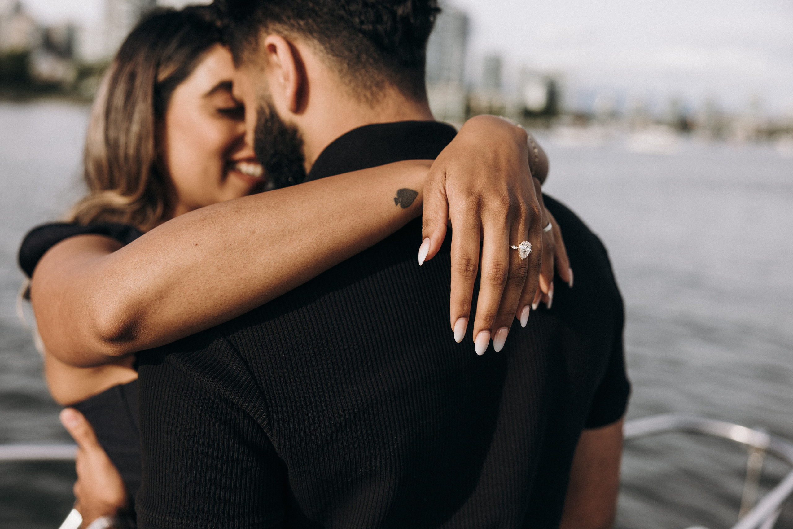 Happy couple celebrating their engagement on a private yacht in Vancouver, photographed at sunset.