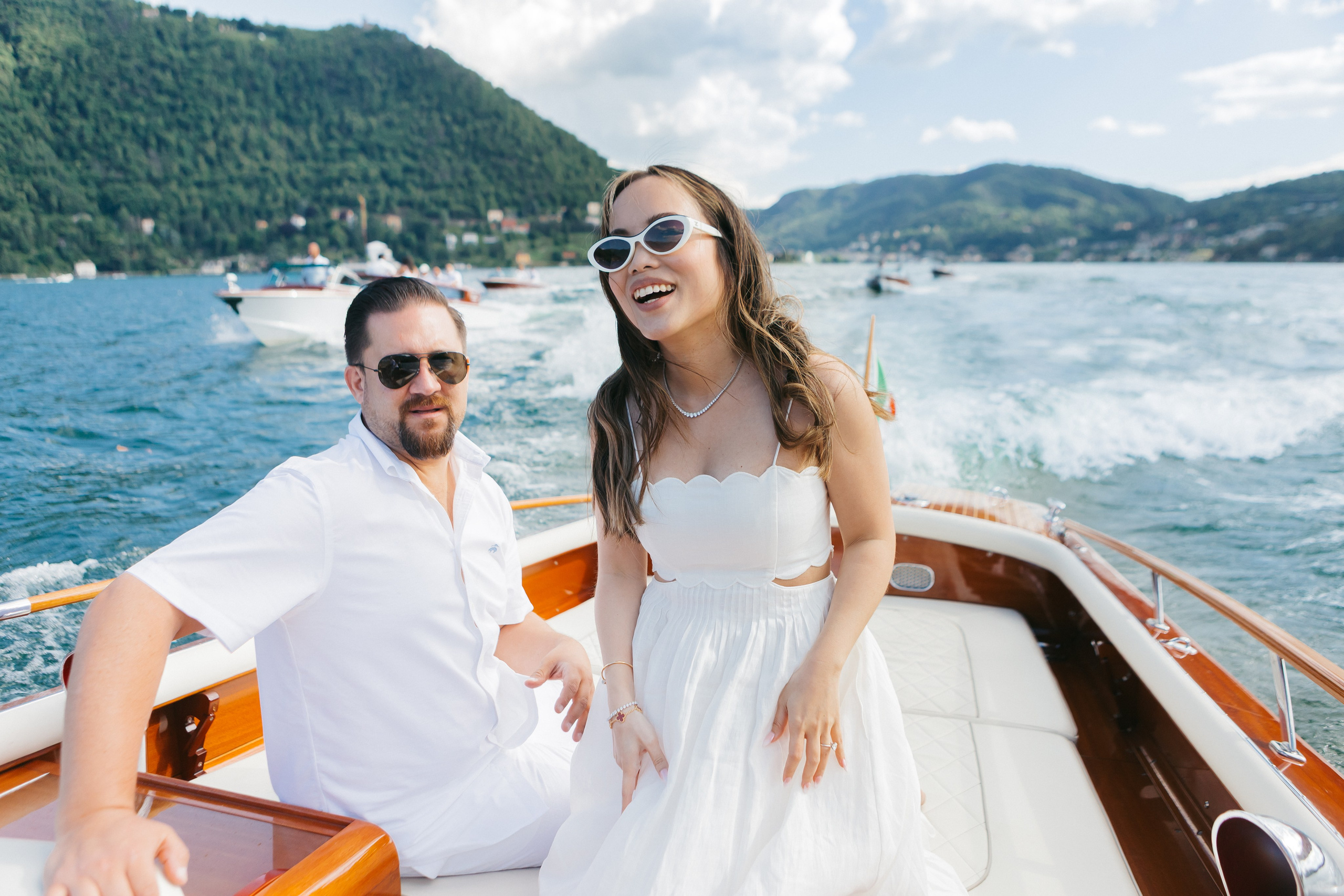 An emotional reportage-style moment capturing the smiling bride during a lively pre-wedding party in Lake Como, highlighting genuine joy and celebration