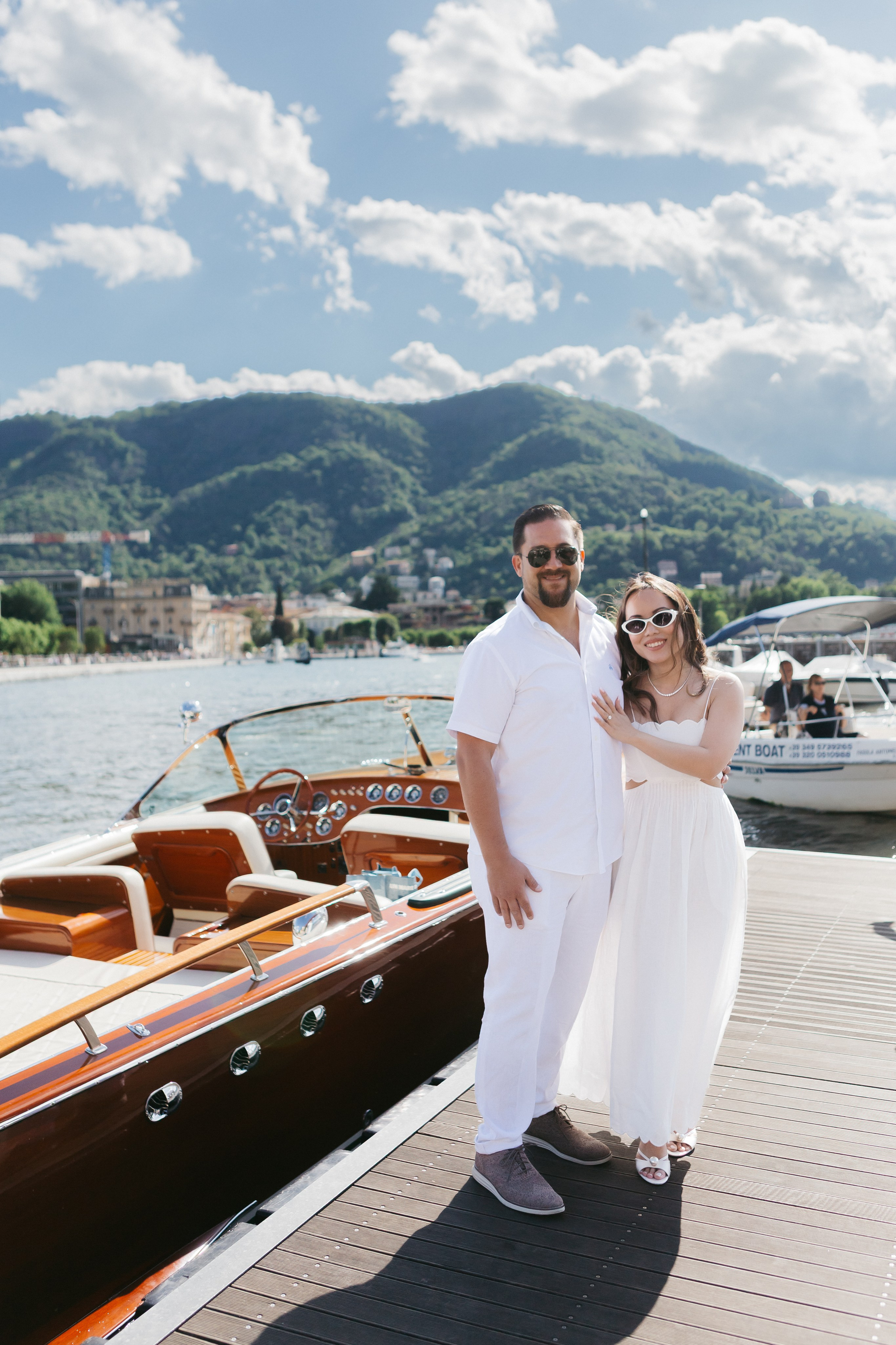 Portrait of a stylish-dressed couple before setting off on a boat at Lake Como