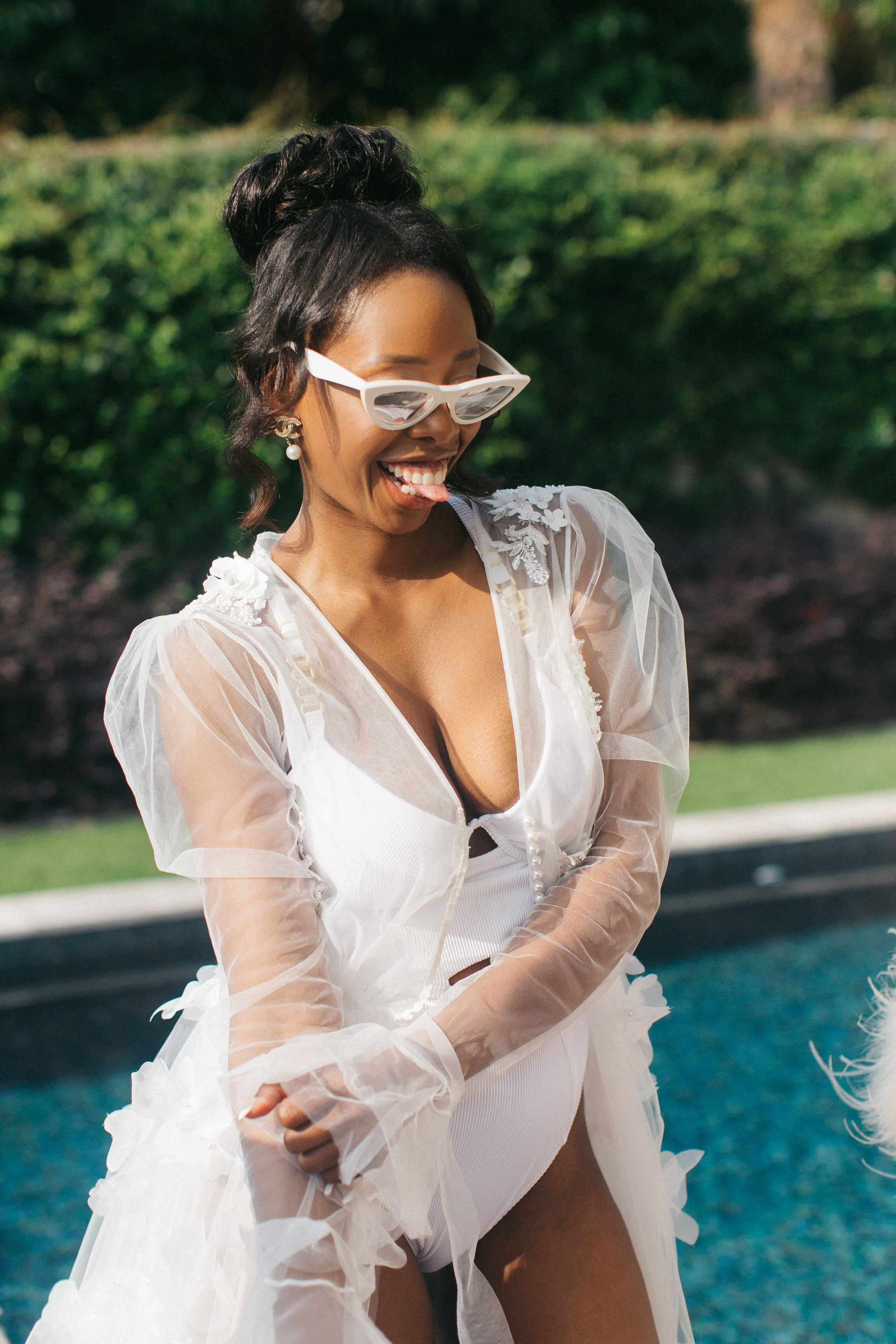 Bride sharing a joyful moment by the pool during a luxury Lake Como wedding