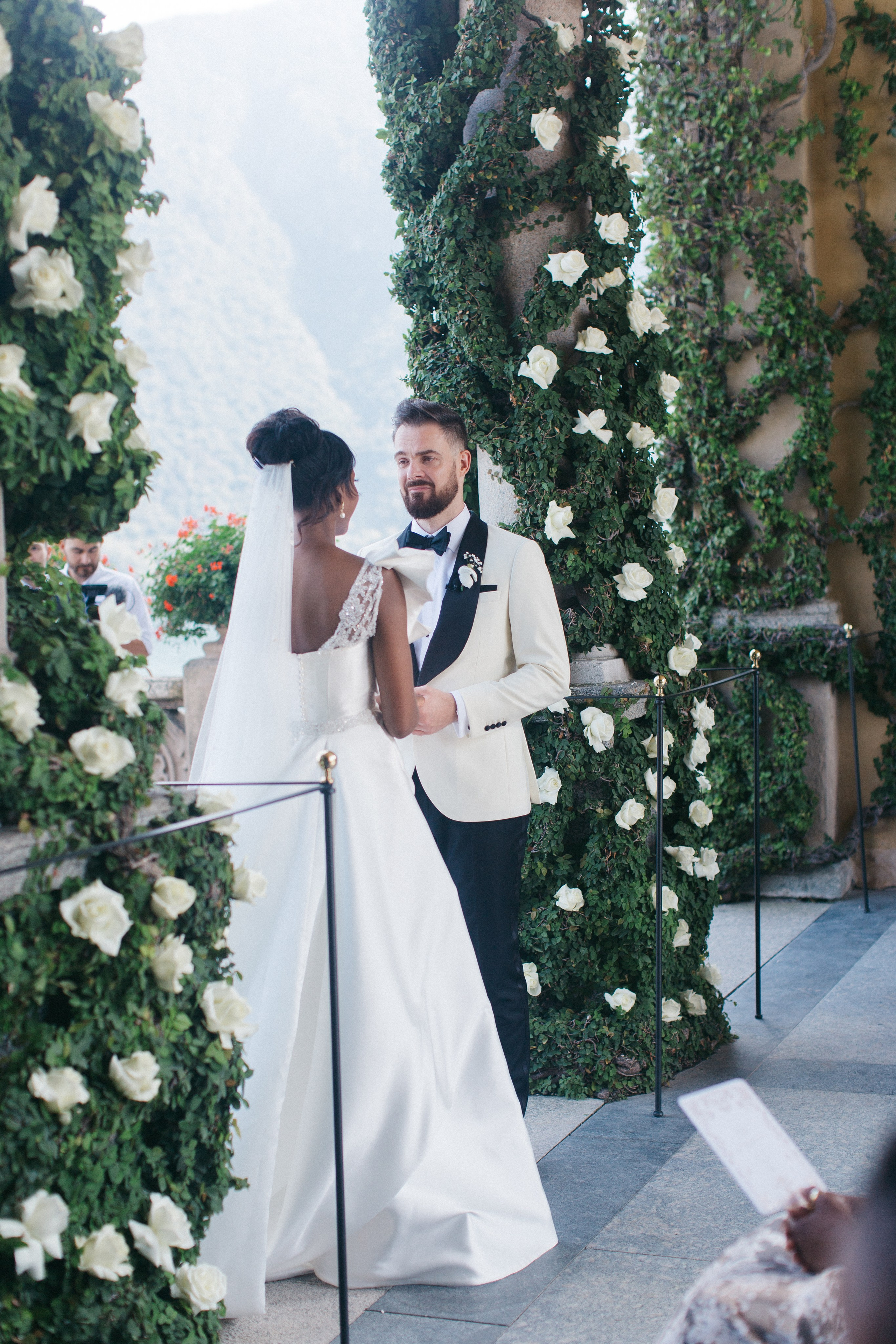 Elegant couple exchanging vows during a wedding ceremony at the scenic Villa Balbianello
