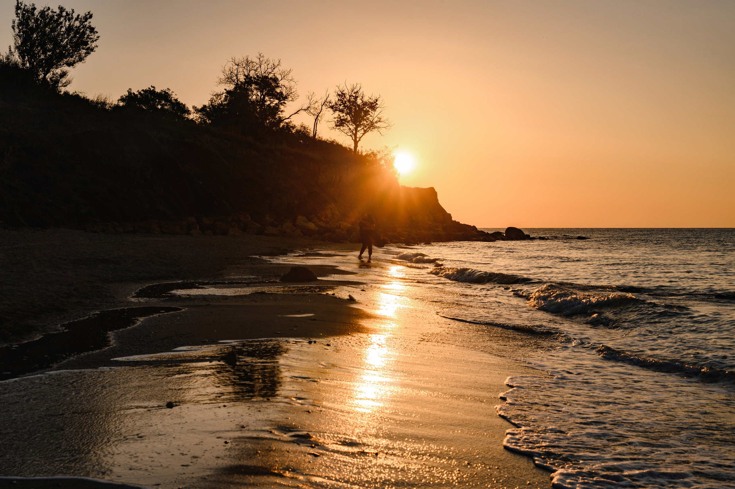Морской рассвет на пляже с камнями