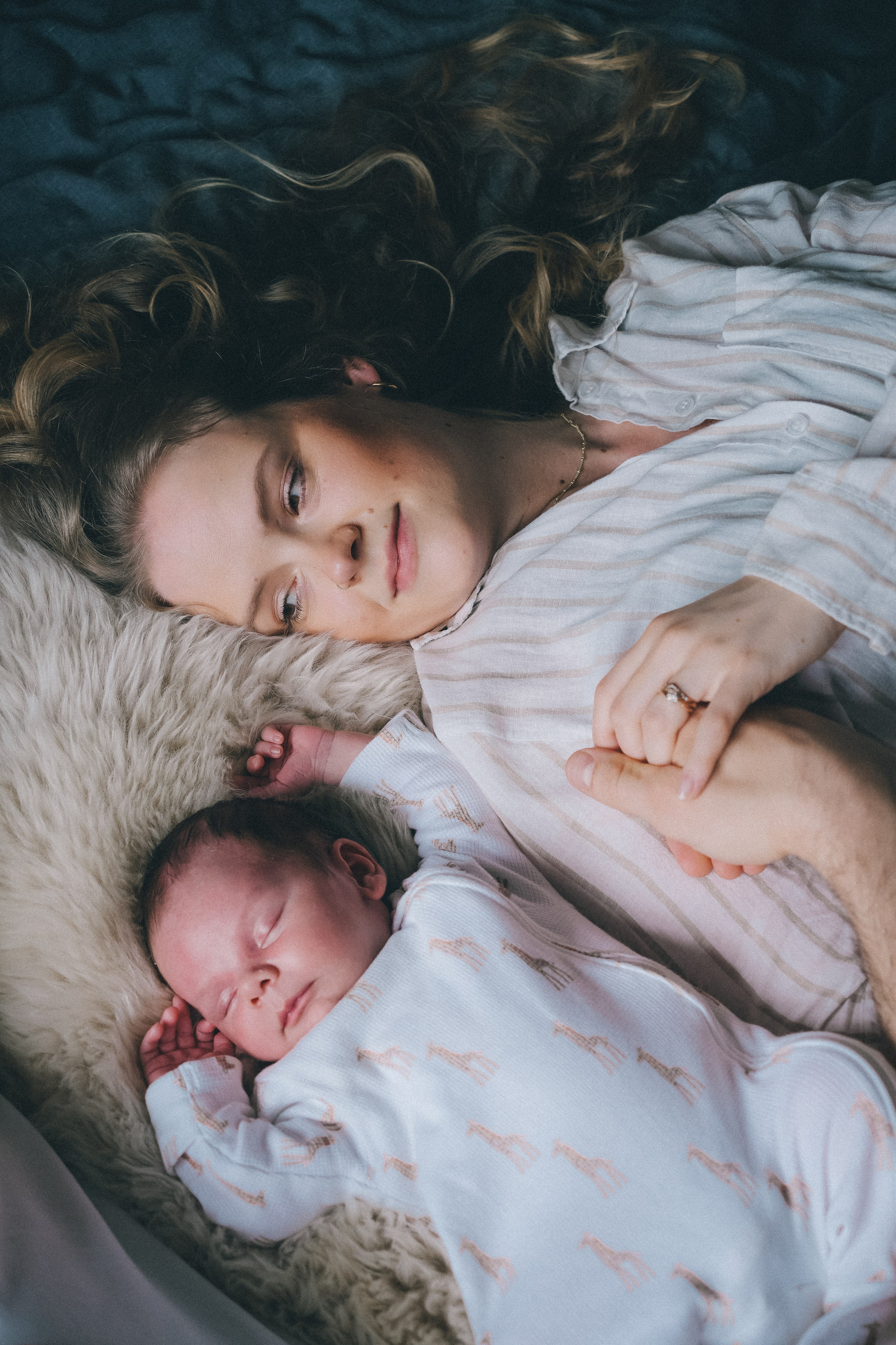 Newborn photography session with mother and baby by newborn photographer in Solihull