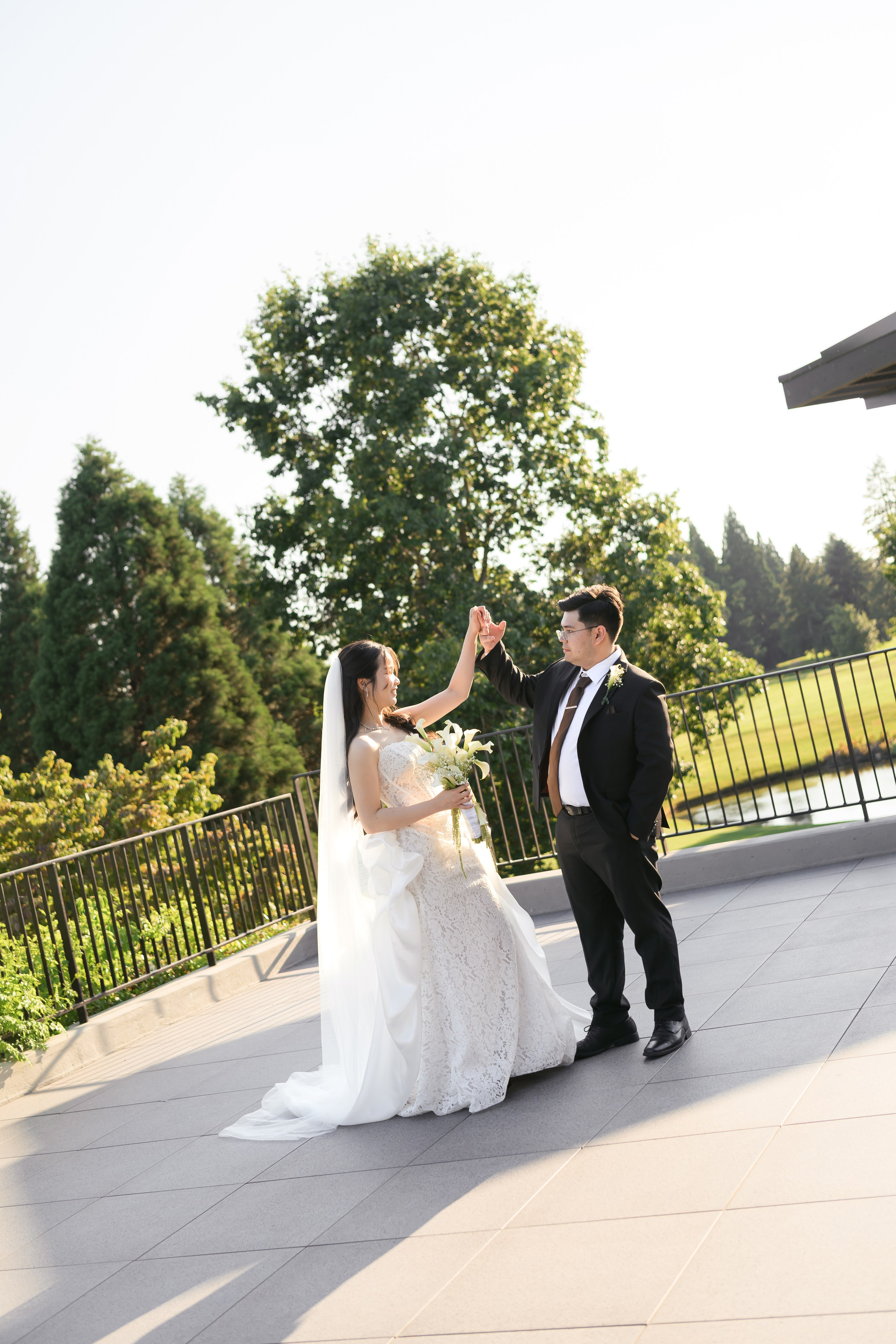 Bride and groom sharing a playful moment during wedding portraits