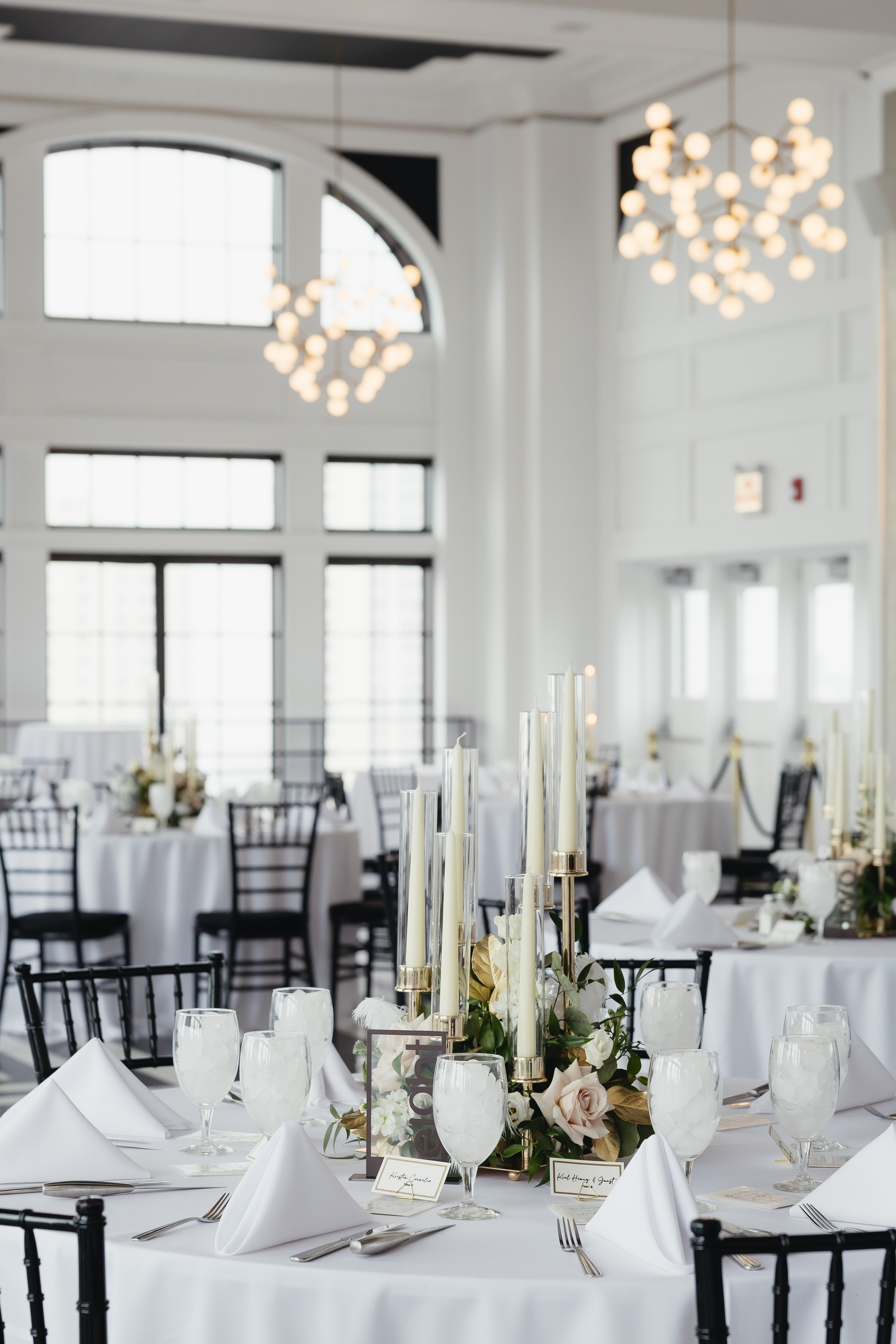 Reception space with tables and wedding decor inside The Penthouse Hyde Park in Chicago