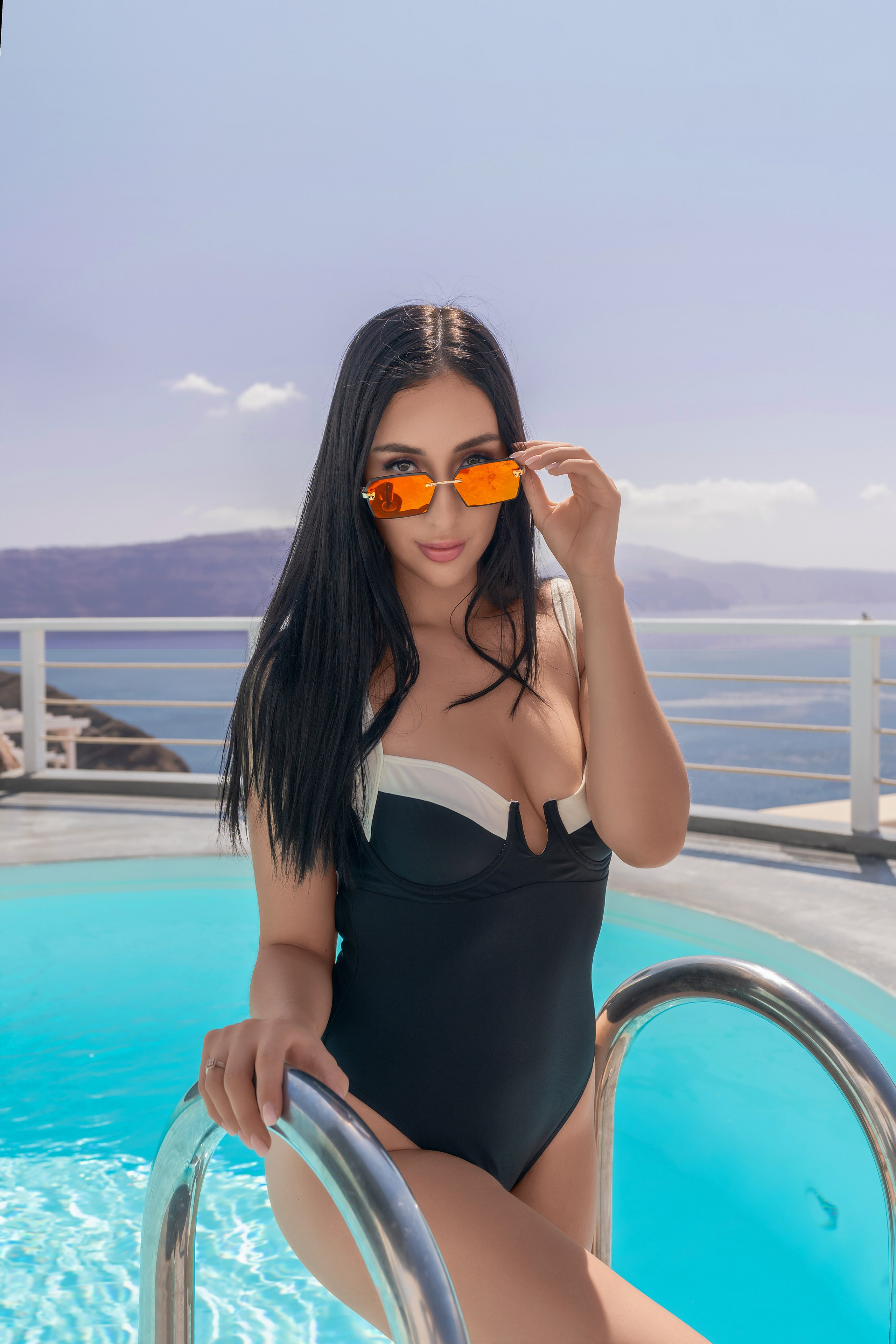 Why Santorini is the Perfect Destination for a Stunning Pool Photo Shoot. Photographer in Santorini SokoLOVE Alex| Flying Dress Santorini