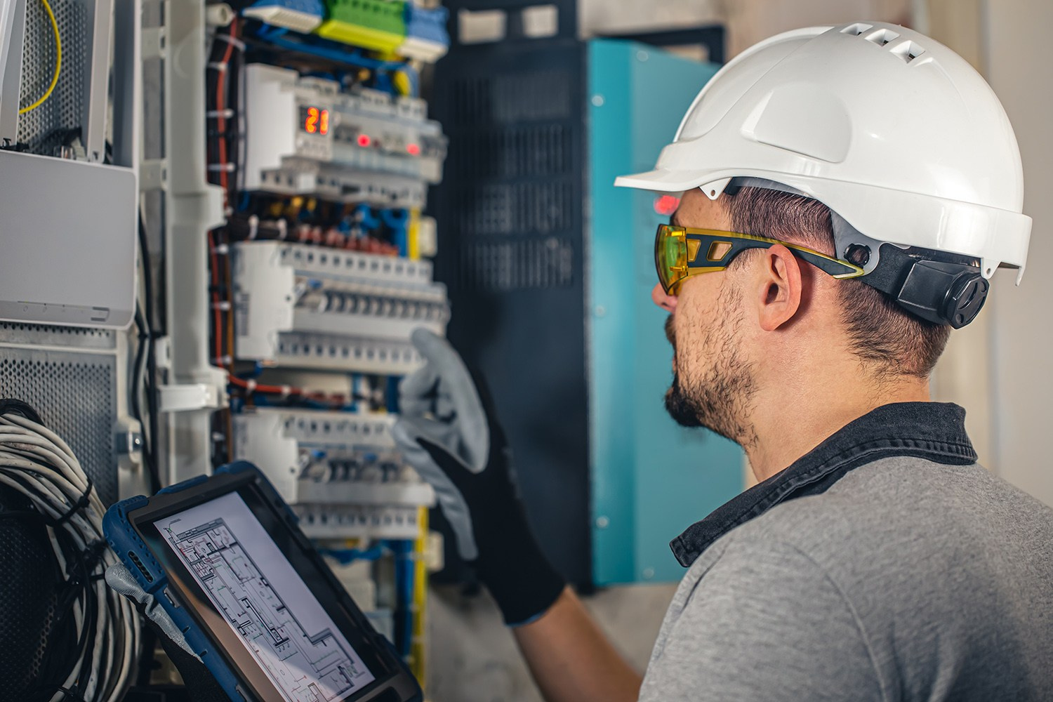 Professional electrician inspecting and upgrading an electrical panel for a safe and modern wiring system in an Athens home renovation.