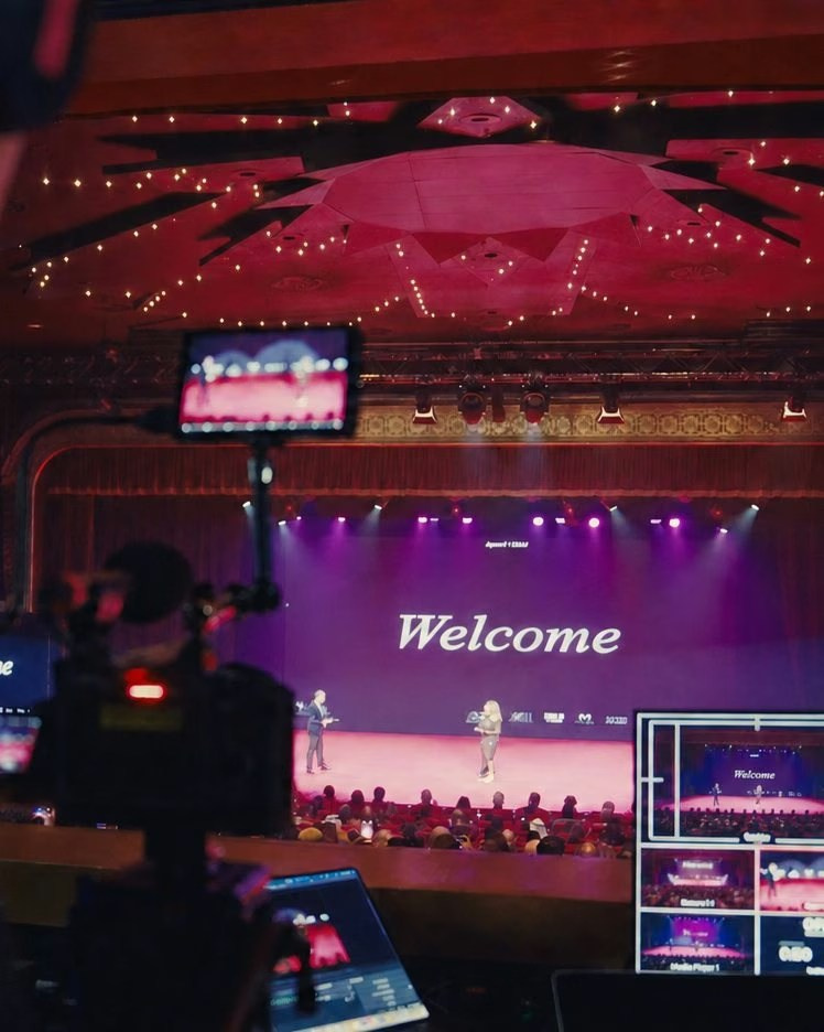 Live broadcast control setup with cameras and monitors during a corporate event