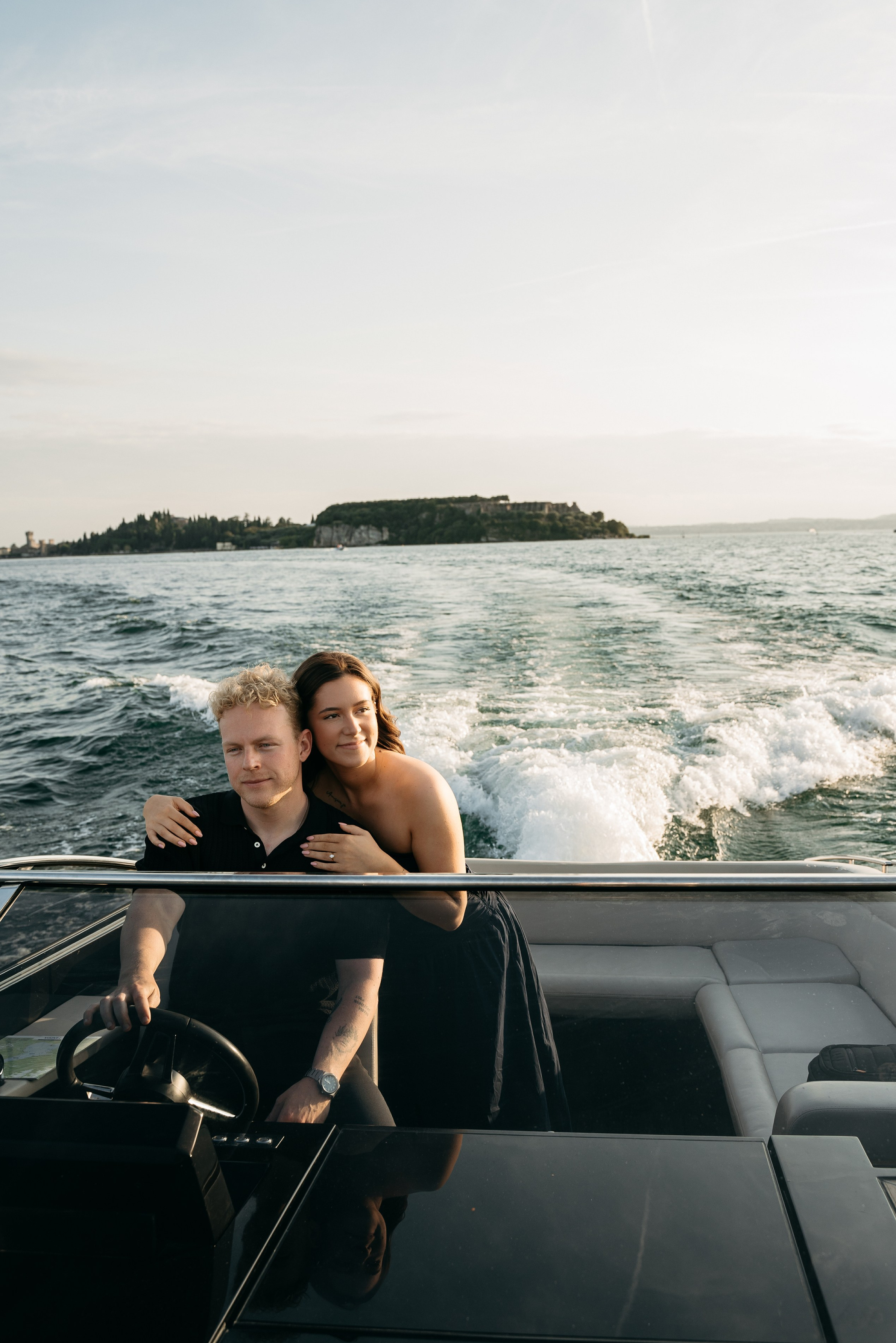 Luxury marriage proposal on a private boat at Lake Garda, romantic couple enjoying sunset in Italy