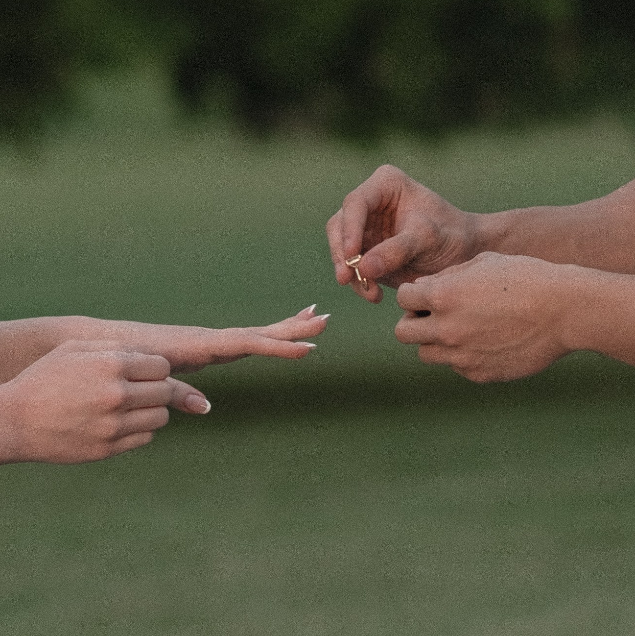 Hands exchanging an engagement ring, close-up detail in Columbus, Ohio
