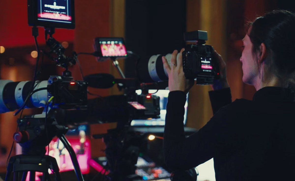 Videographer operating multiple cameras during a corporate event production in the UAE
