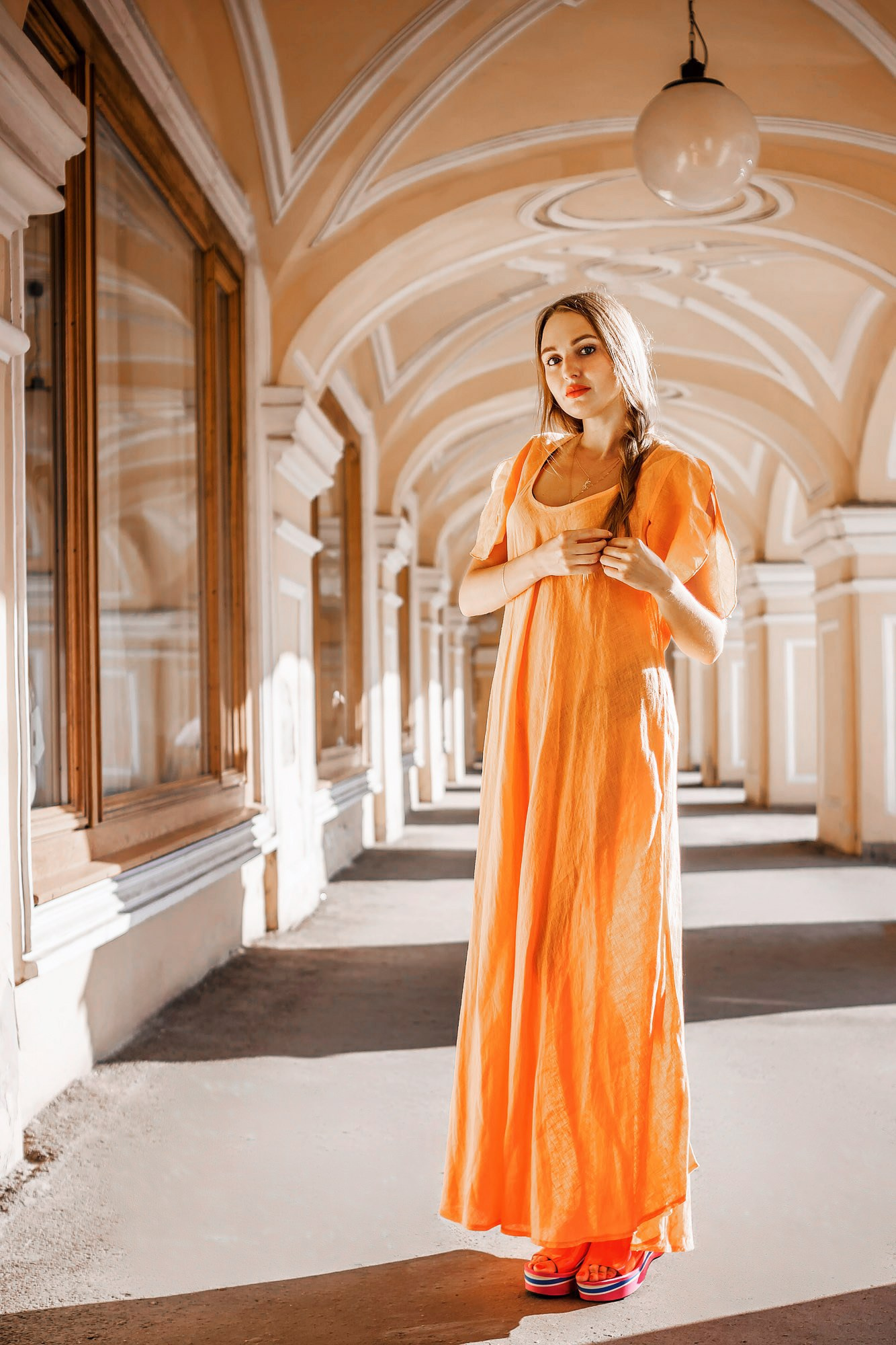 Woman in a long traditional dress on the street, captured in a beautiful outdoor setting