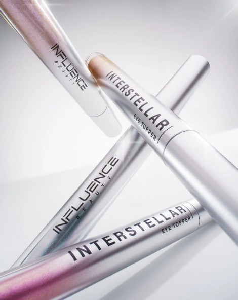 Metallic cosmetic pencils arranged diagonally — editorial beauty product shoot London studio