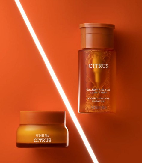 Amber skincare jars with geometric light beams — contemporary product photography setup.