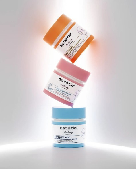 Skincare jars floating with soft white backlight — modern beauty product photography London.