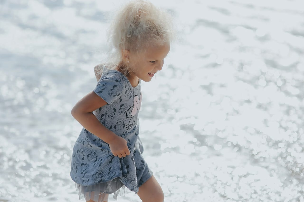 Cute little girl playing near the ocean during a Santa Monica kids photoshoot