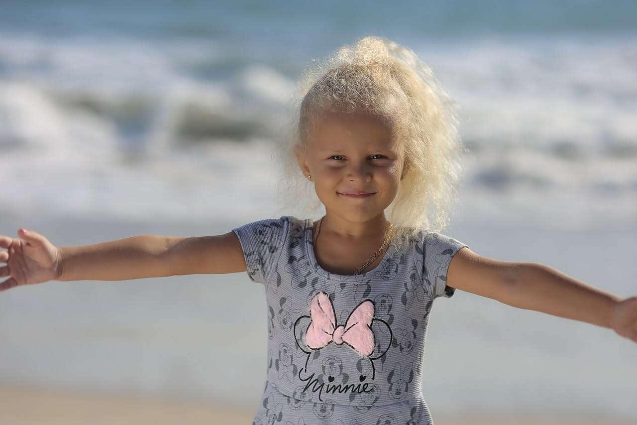 Little girl's bright smile captured during a Santa Monica Beach Pier photoshoot