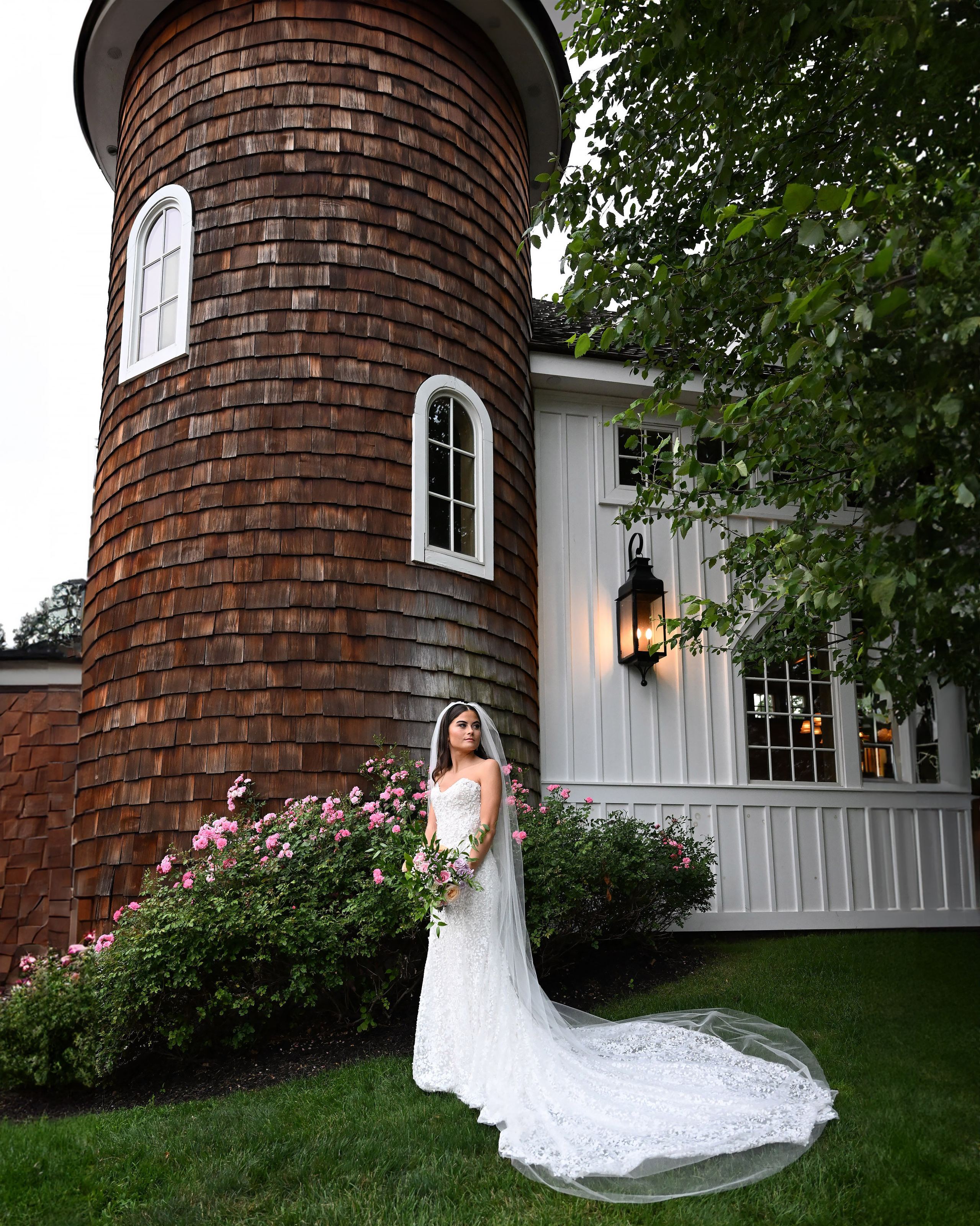 a bride standing in front of a large brick building