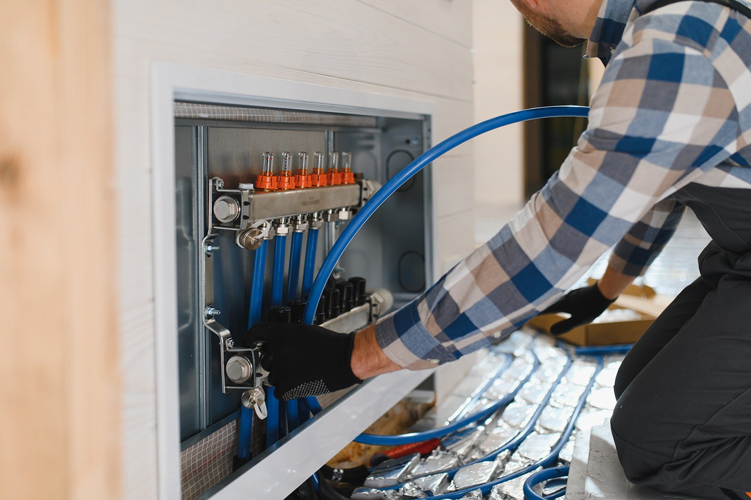 Professional installing modern plumbing and heating distribution pipes in an Athens apartment renovation.