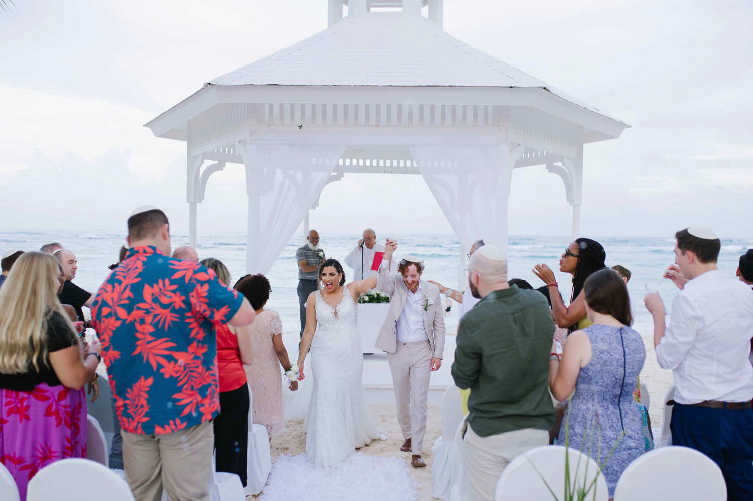 The bride and groom walk together after the wedding ceremony. 