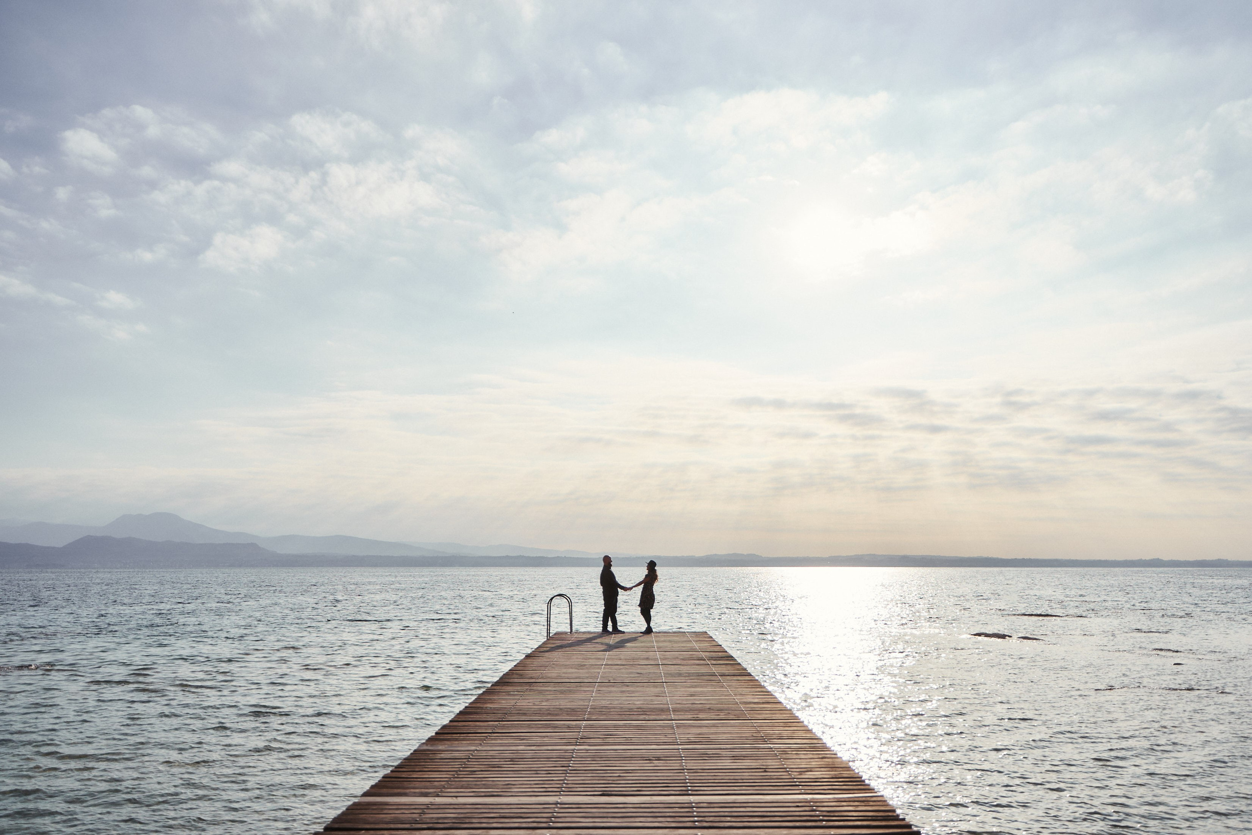 Happy couple after wedding near lake garda and mountains Mount Baldo.