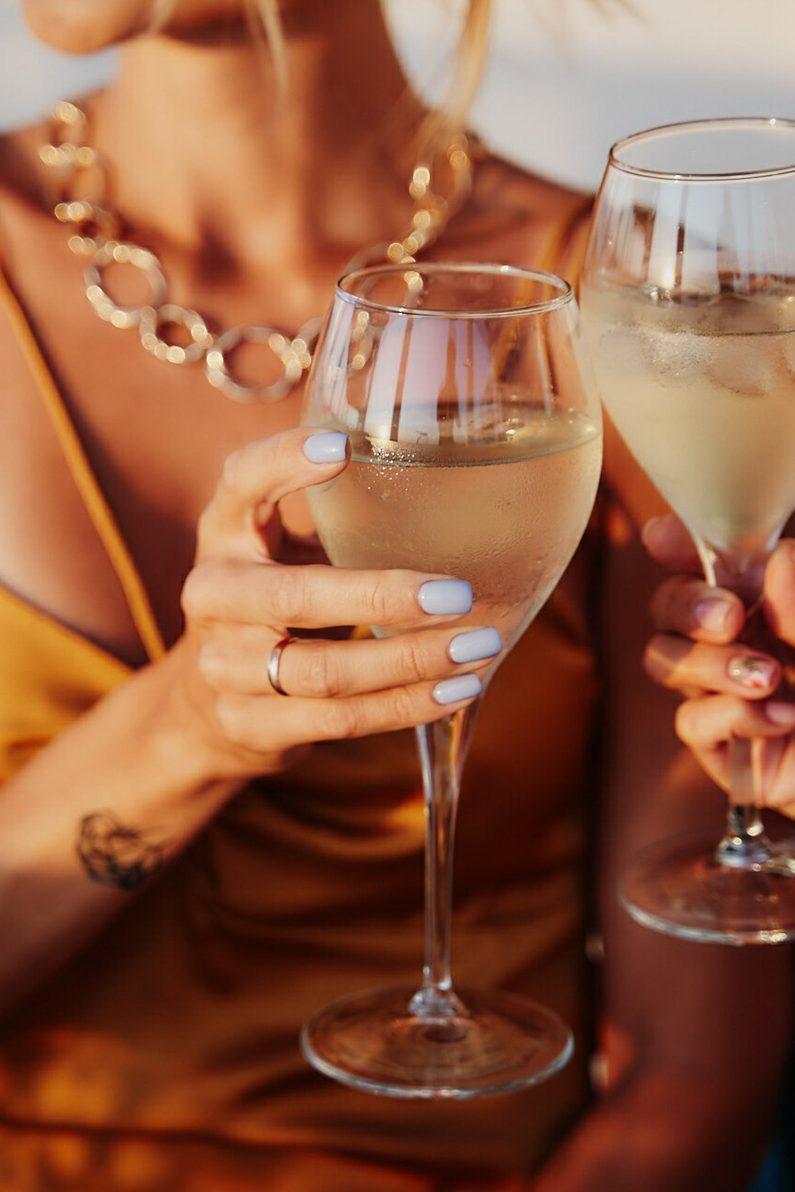 Woman holding a glass of champagne by the pool