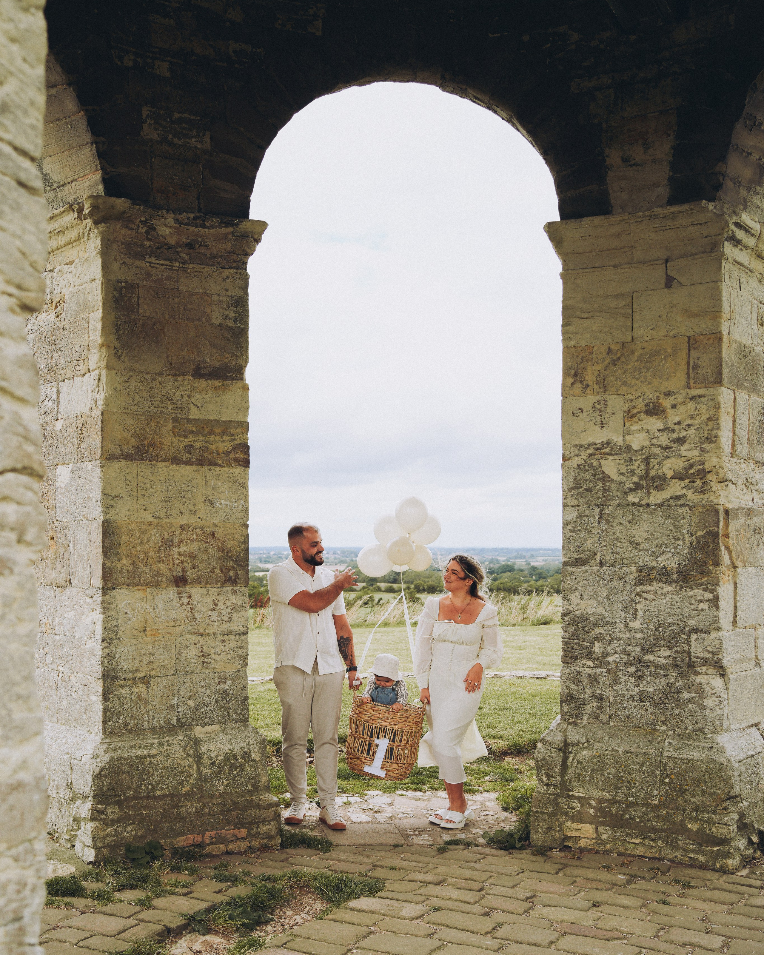 a man is walking with twins and seeing the reflection. Family photography in Solihull. 
