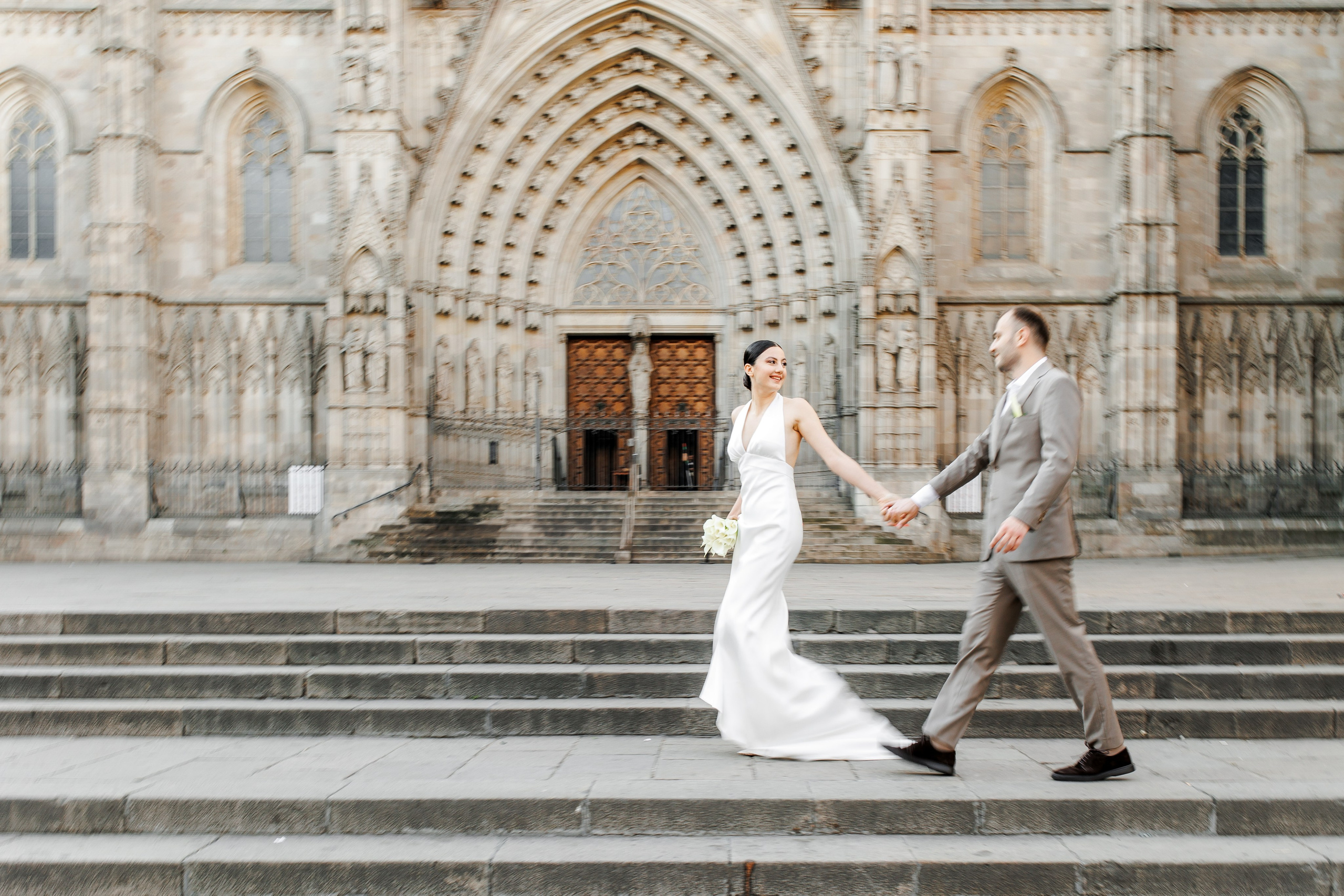A couple walking through the Gothic Quarter alleyways during a romantic photoshoot