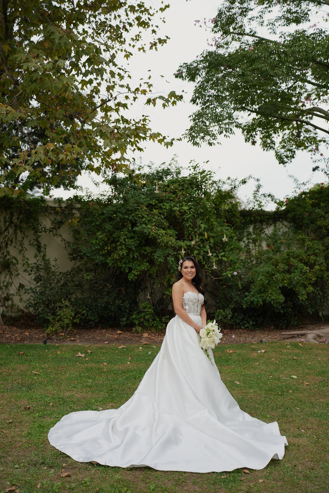 Bride wearing elegant classic wedding dress in a garden style venue in Los Angeles