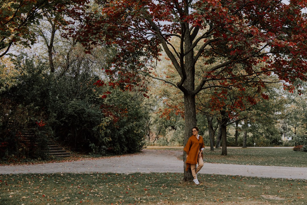 Woman walking through a Calgary park during a fall photography session