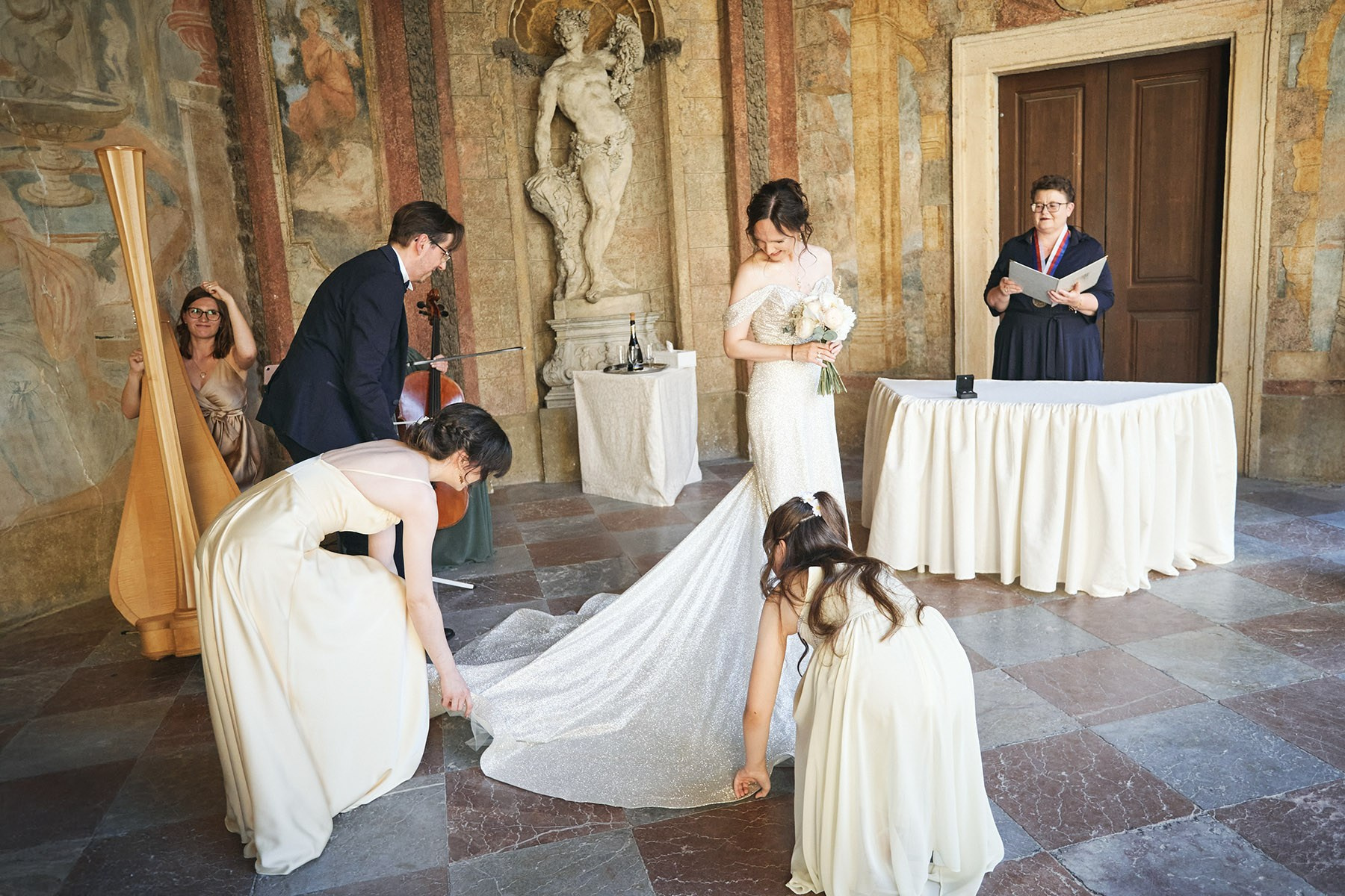 Vladimir and his daughters adjust Ina's dress at the start of the ceremony