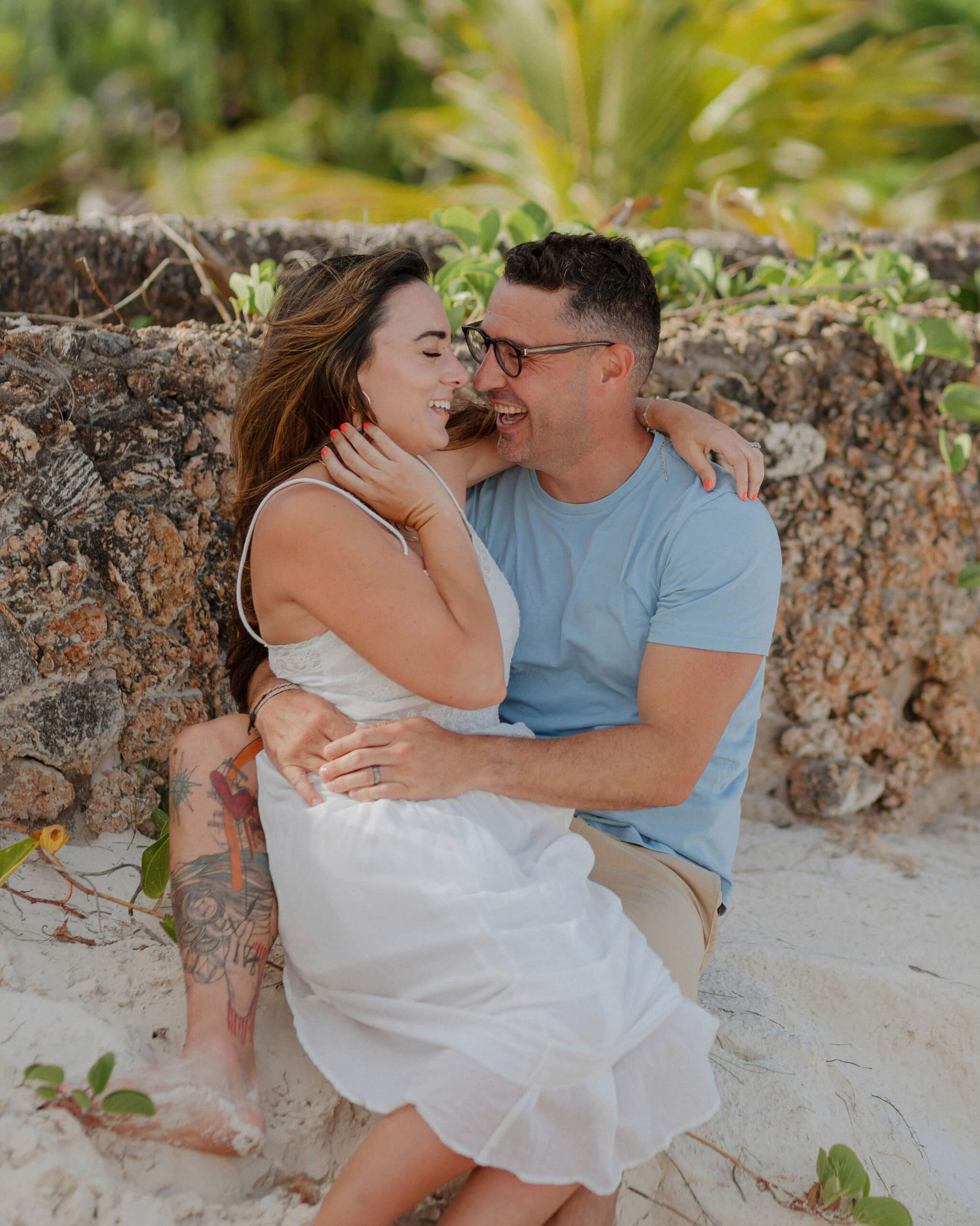 Kenya anniversary couple photography in Mombasa, loving embrace by rocks.