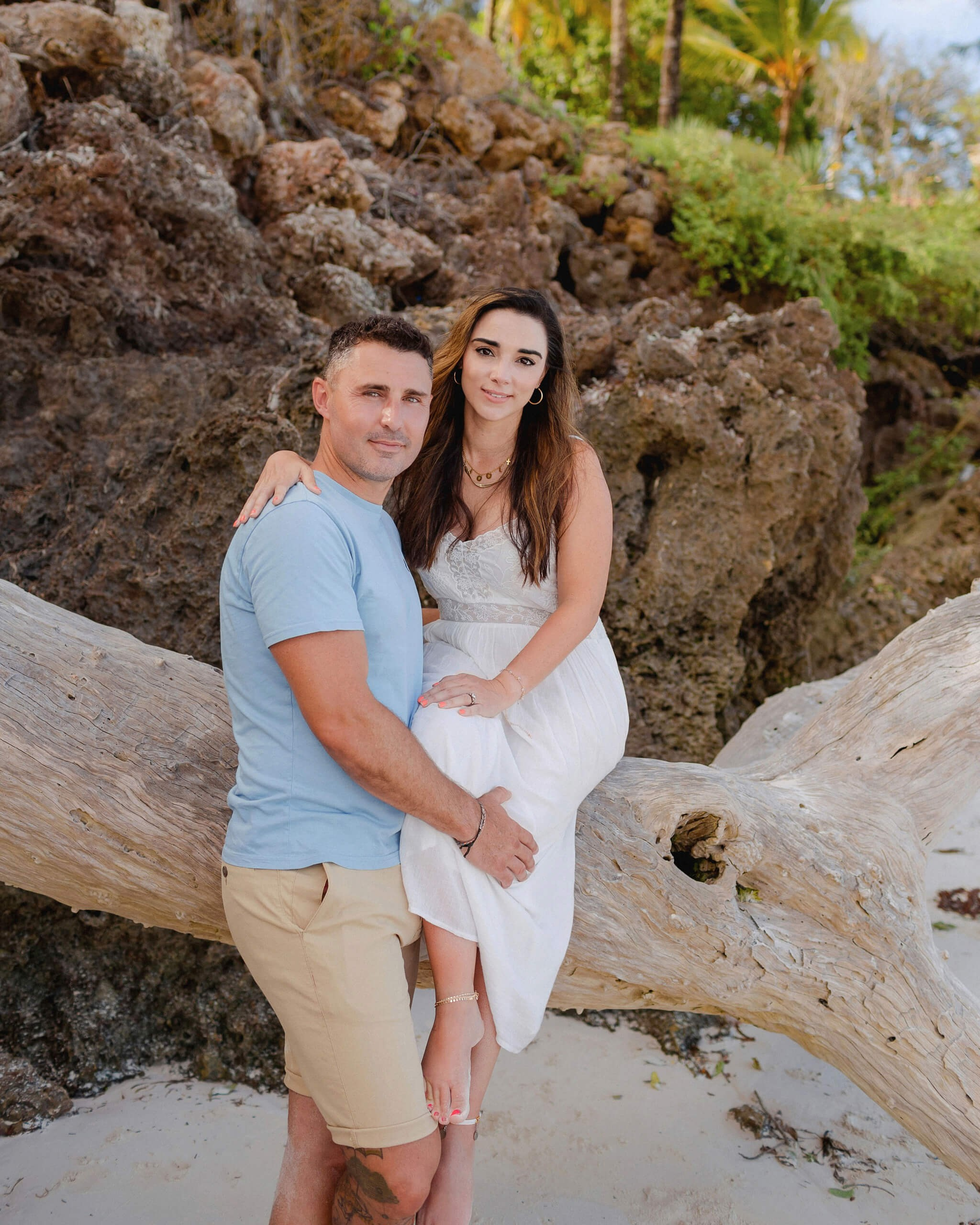 Romantic couple sitting on driftwood, Mombasa anniversary session.