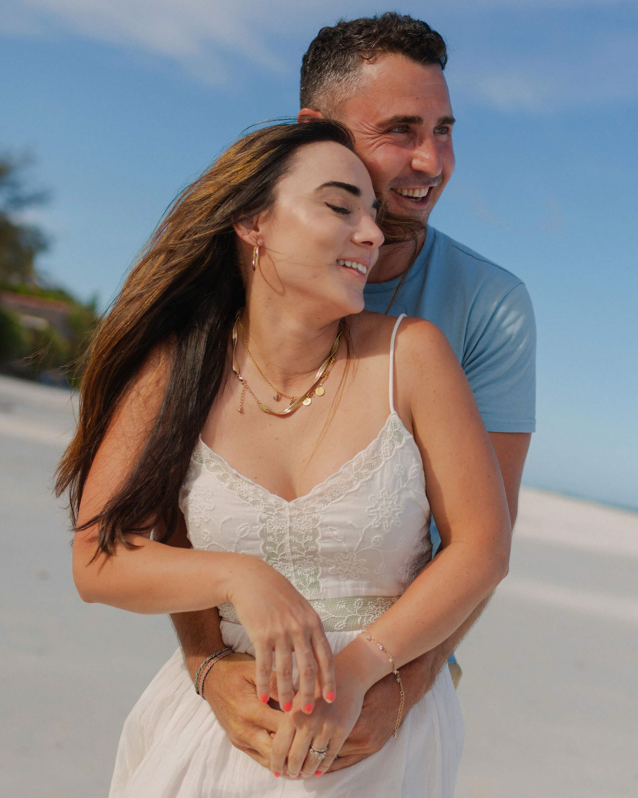 Watamu couple portrait, tight embrace on white sands of Kenya.