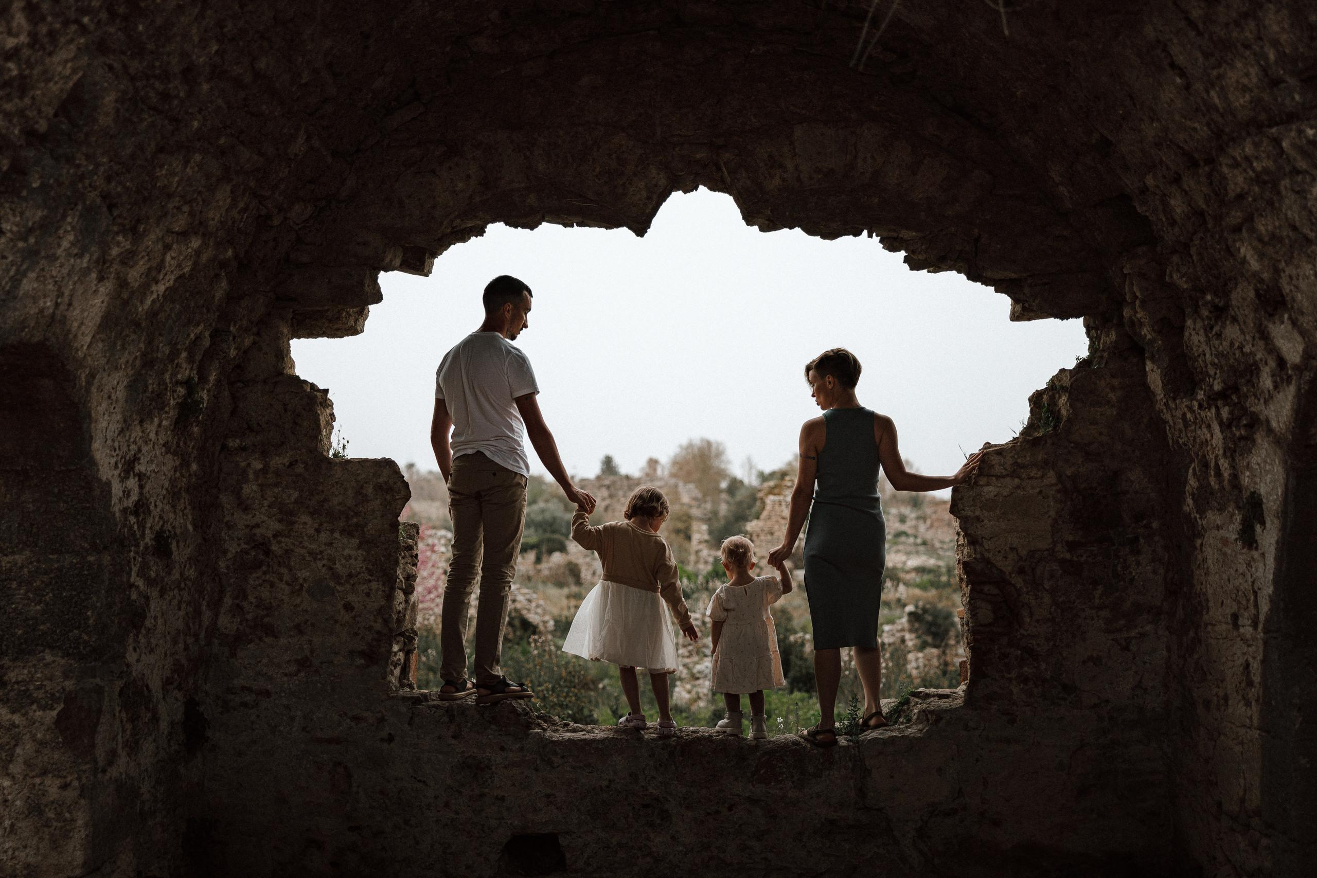 Family walk through the ancient ruins. Side