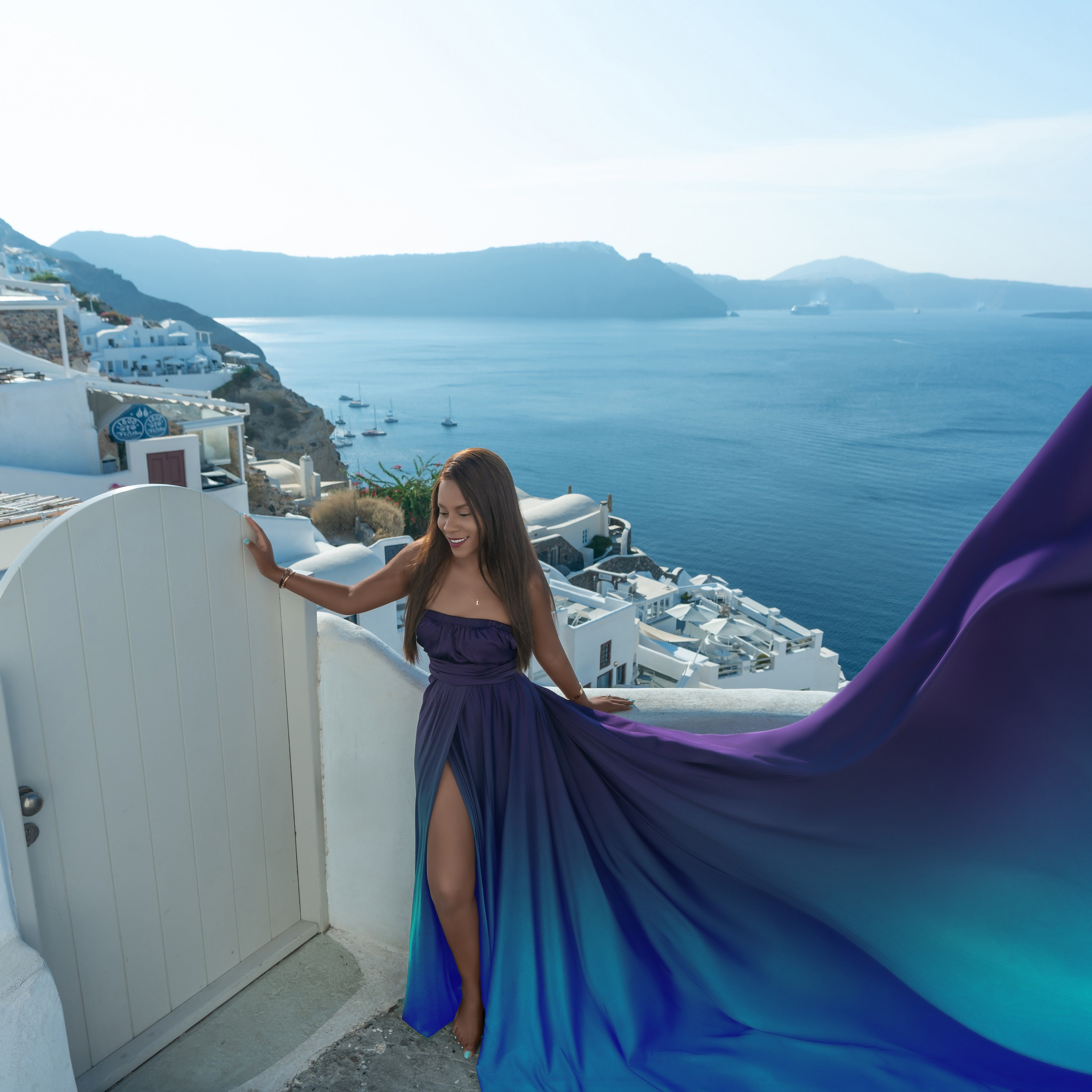 Grace and Glamour: A&nbsp;Couple’s Dream Photoshoot in&nbsp;Oia with a&nbsp;Violet Flying Dress