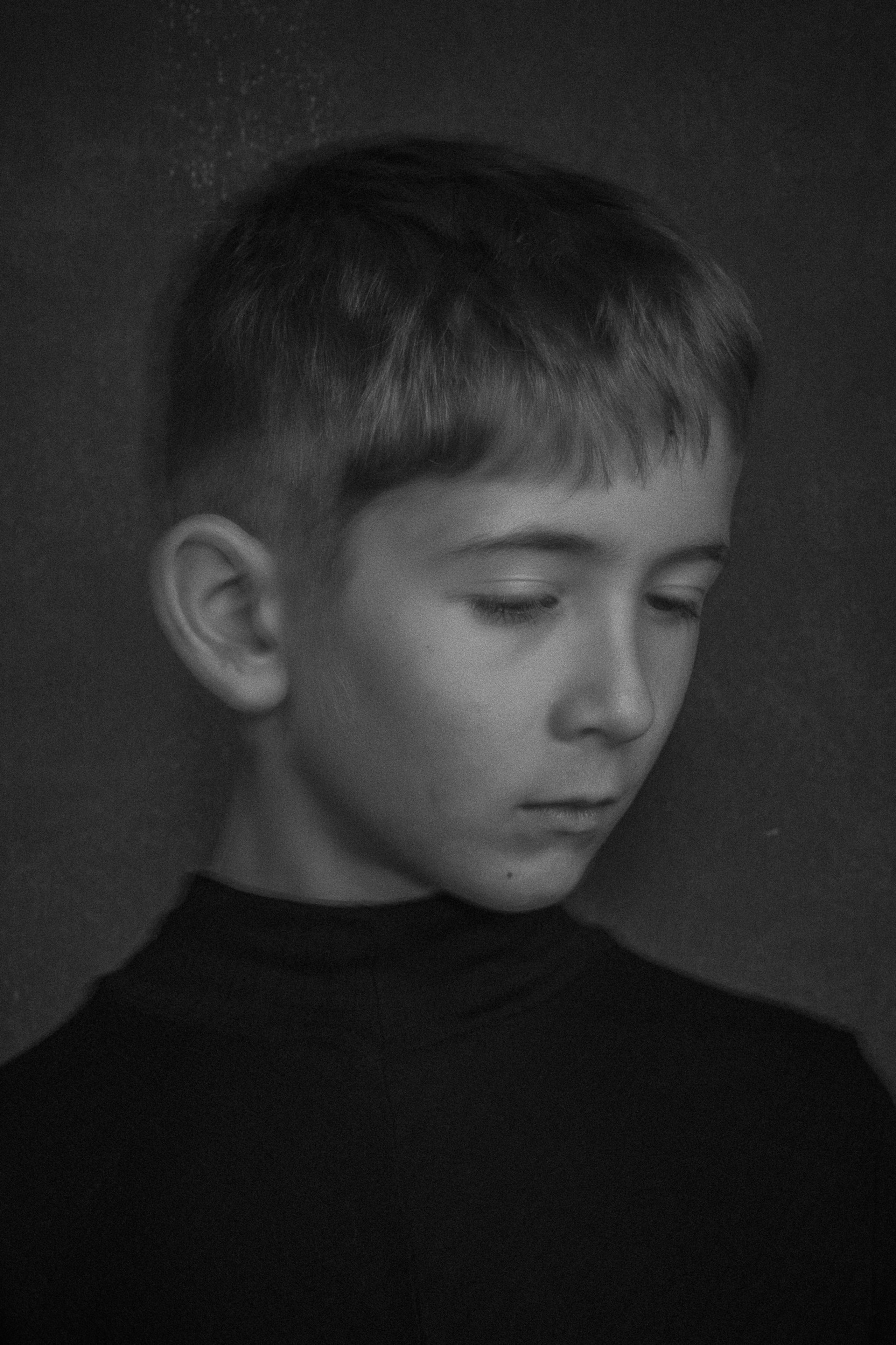 black and white portrait of a boy capturing a moment of contemplation 
