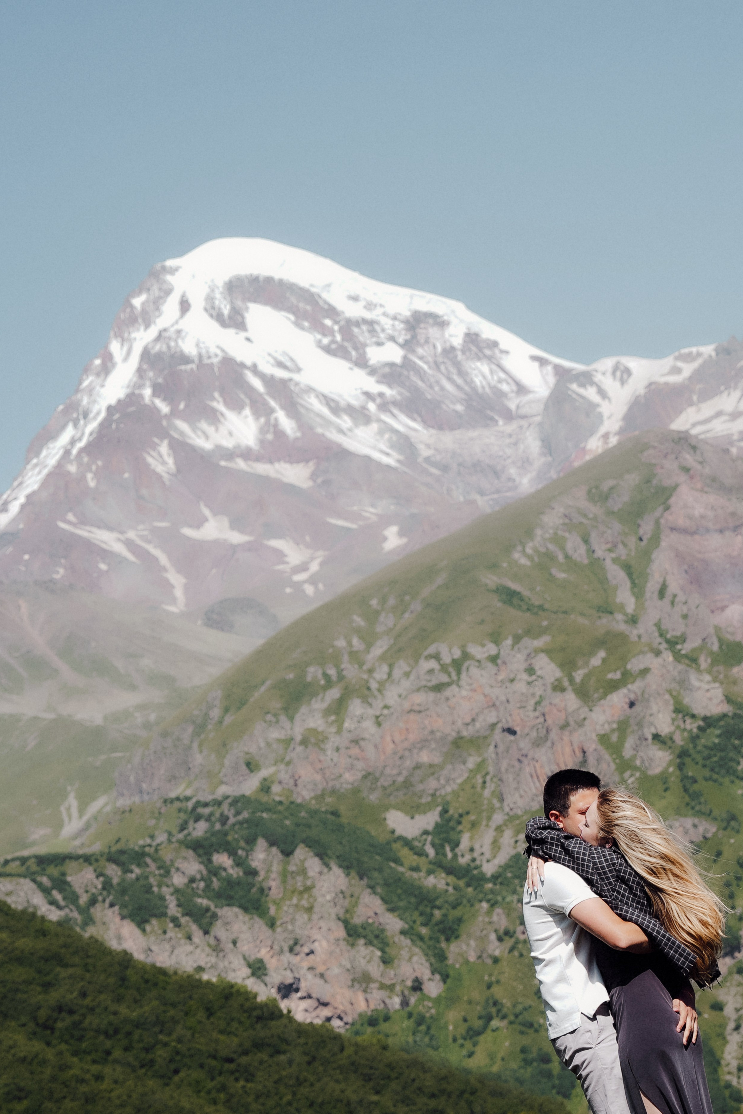 Romantic mountain escape for two, captured in soft golden light in Kazbegi