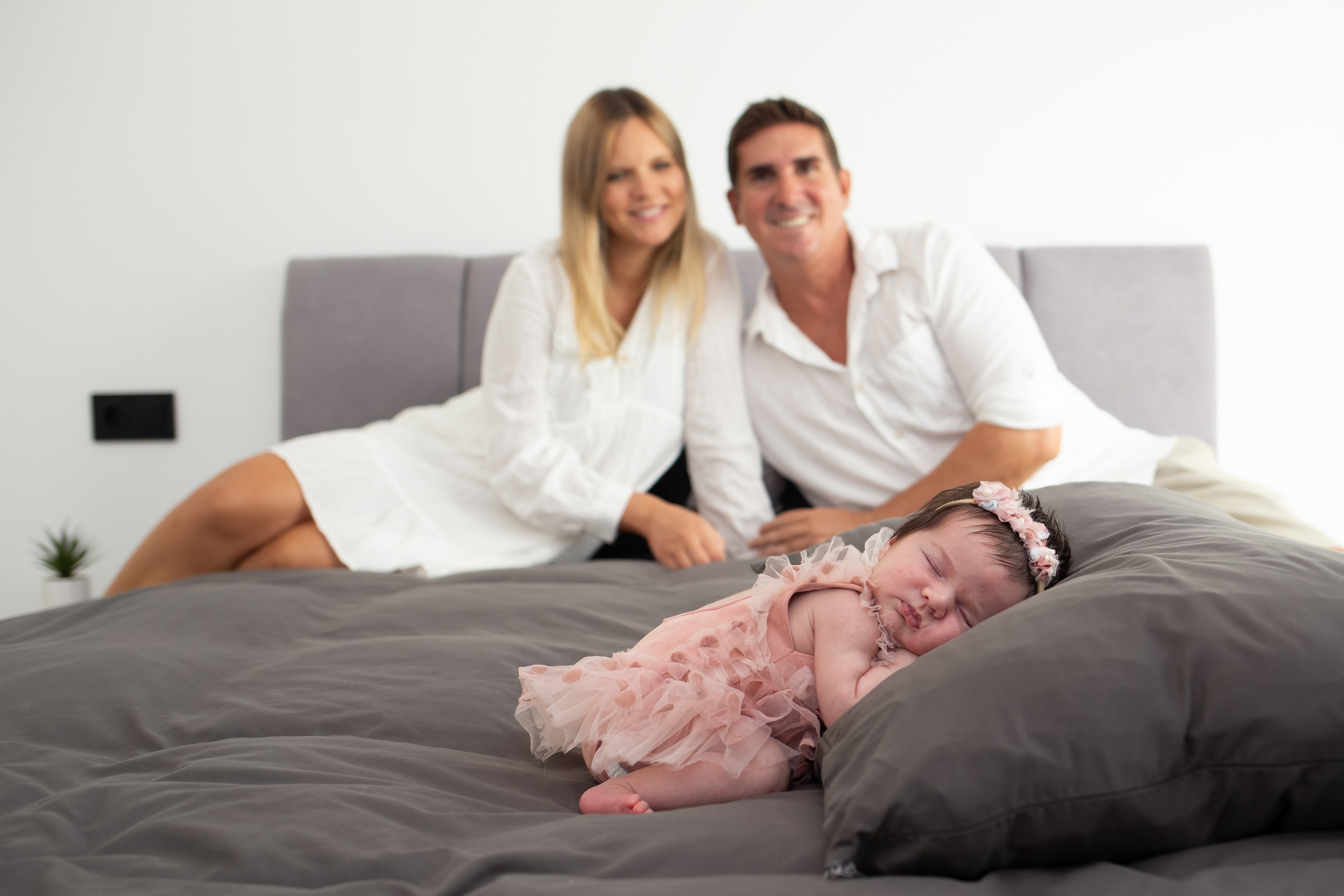 Parents holding their newborn baby at home