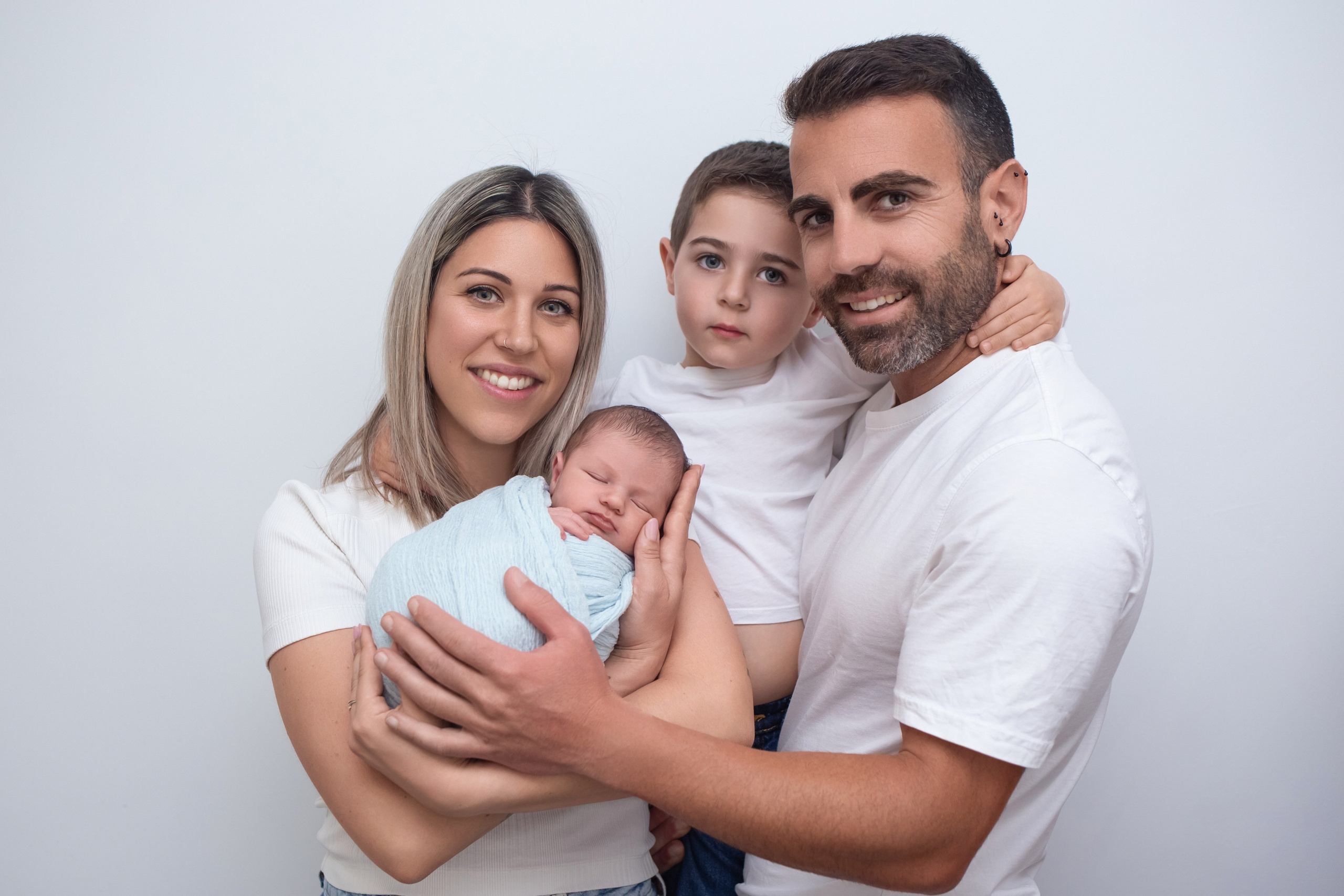 Newborn baby with parents during a photoshoot