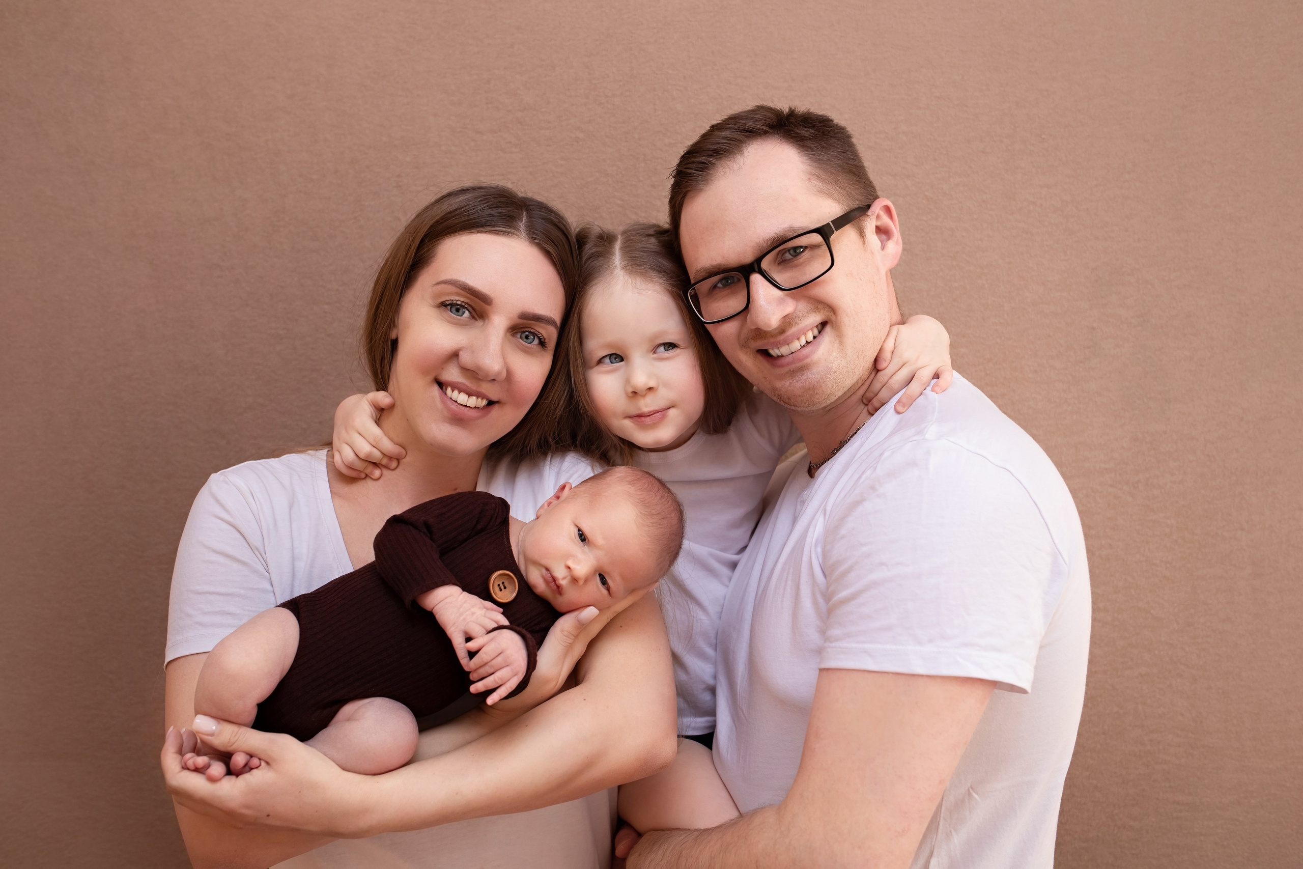 Father holding his newborn baby during a photoshoot