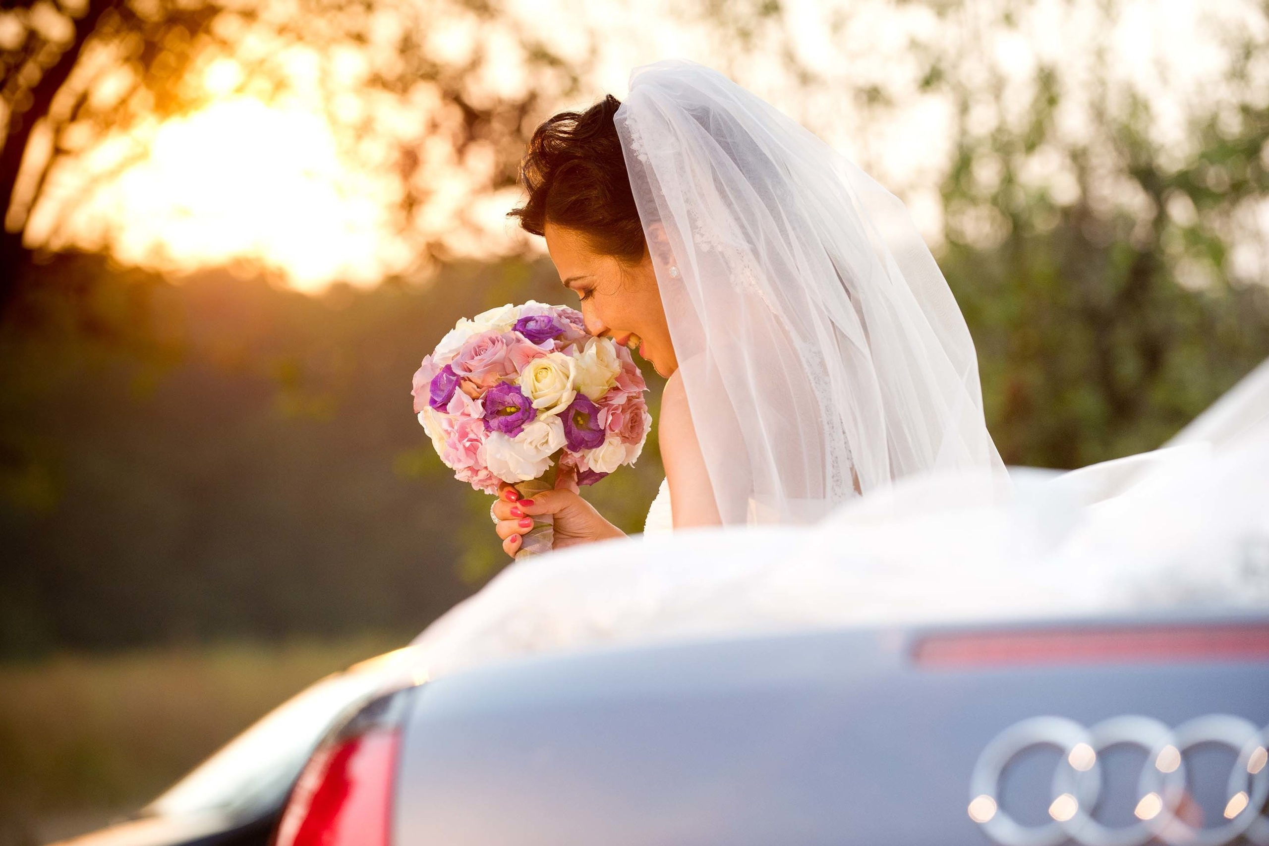 Wedding photographer Snagov Palace, Bucharest Romania UK Bride smelling flowers near Audi S line  Nikon D850